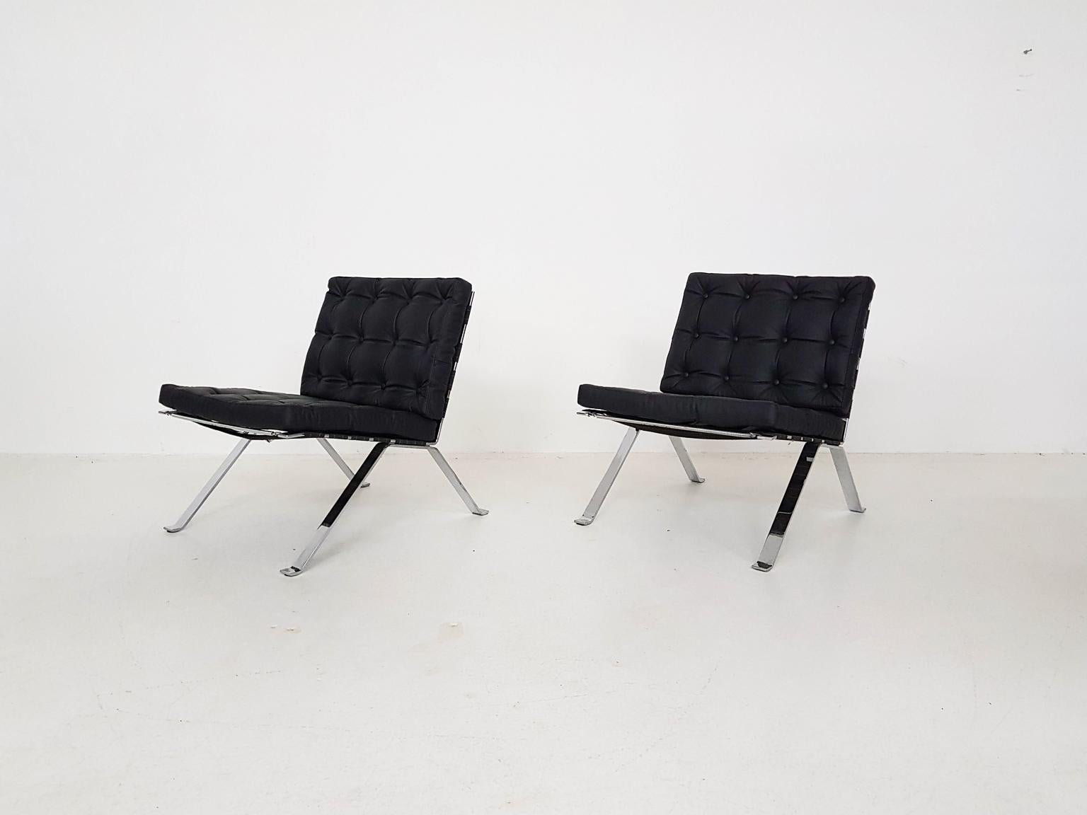 A pair of lounge or easy chairs with a heavy chromed base and tuffed leather cushions designed by Hans Eichenberger for Girsberger and made in Switzerland in 1966. This model is called 