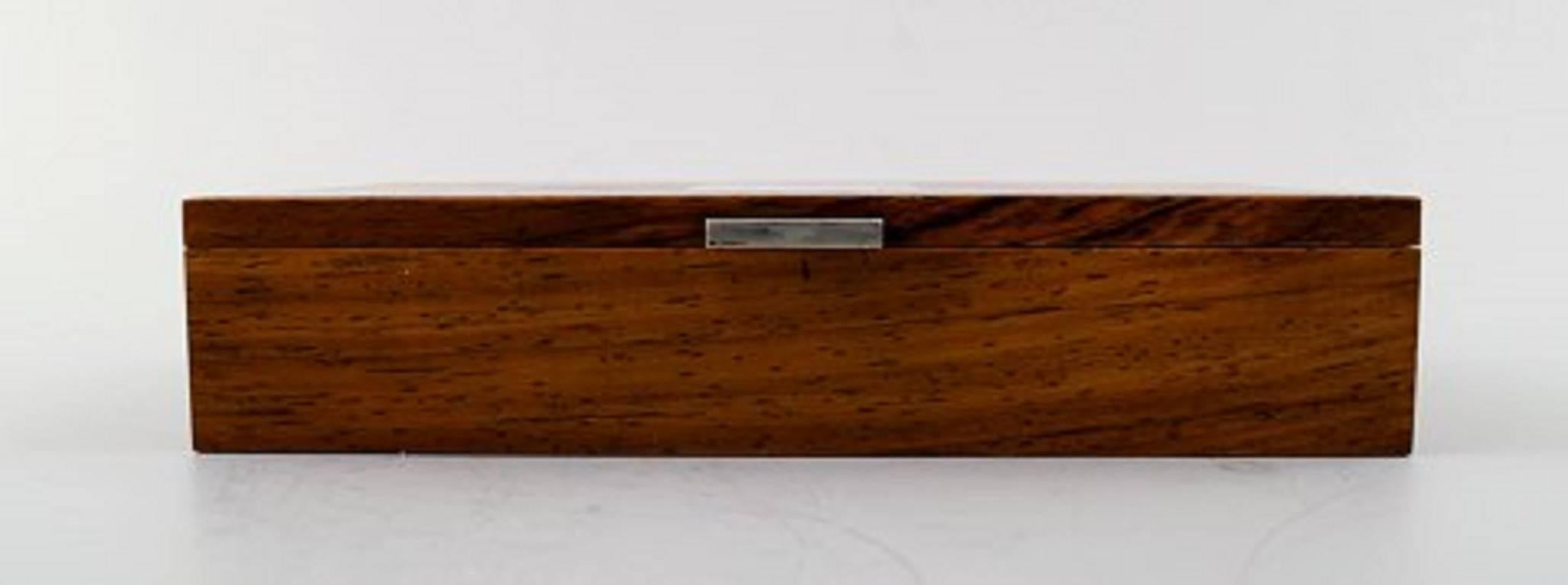 Hans Hansen: Casket or box in rosewood inlaid with silver.
Marked Hans Hansen.
Mid-20th century. Danish design.
Measures: 18 cm. x 11 cm. x 3.5 cm.
In perfect condition.