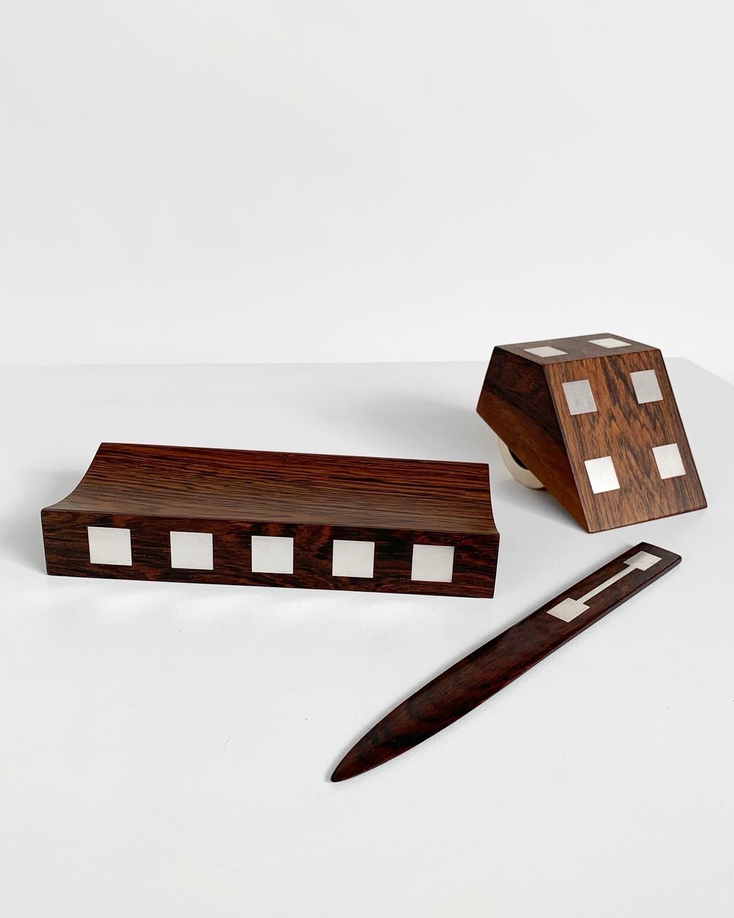 Rare desk set by Danish silversmith Hans Hansen, hand-crafted in Denmark in the 1960s.

Letter opener, pen tray & ink roller made of rosewood & solid Sterling Silver inlays. The ink roller comes with the original blotting paper.

Pen tray W: 20