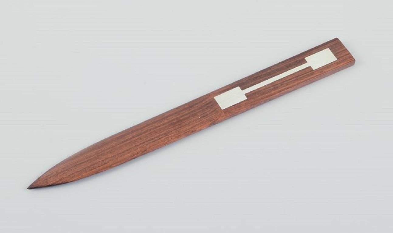 Hans Hansen. Brieföffner aus Palisanderholz mit Silbereinlage.
Dänische Moderne.
Um 1960.
Abmessungen: L 22,5 cm. X D 2,0 cm.
In ausgezeichnetem Zustand.