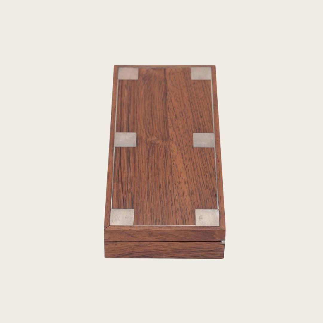 1960s, Sweden. This elegant rosewood box features a sterling silver inlay and is marked “925S Hans Hansen Sterling Denmark” on the bottom.