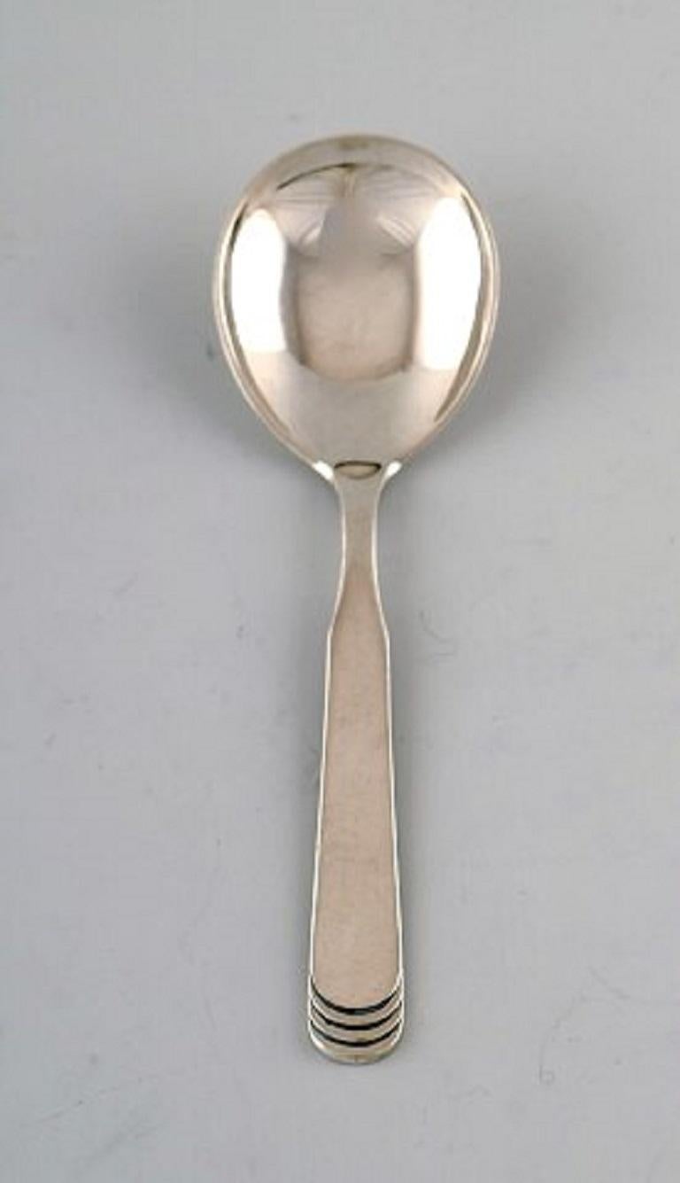 Hans Hansen silverware number 15. Sugar spoon in silver. Dated 1936. 
Measures: 13.5 cm.
In very good condition.
Stamped.
2 pieces.