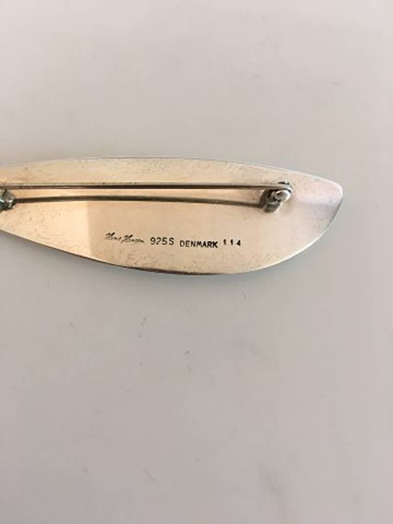 Hans Hansen Sterling Silver Brooch No 114. Measures 7.6 cm / 2 63/64 in. Weighs 15.6 g / 0.55 oz. Is in good condition.