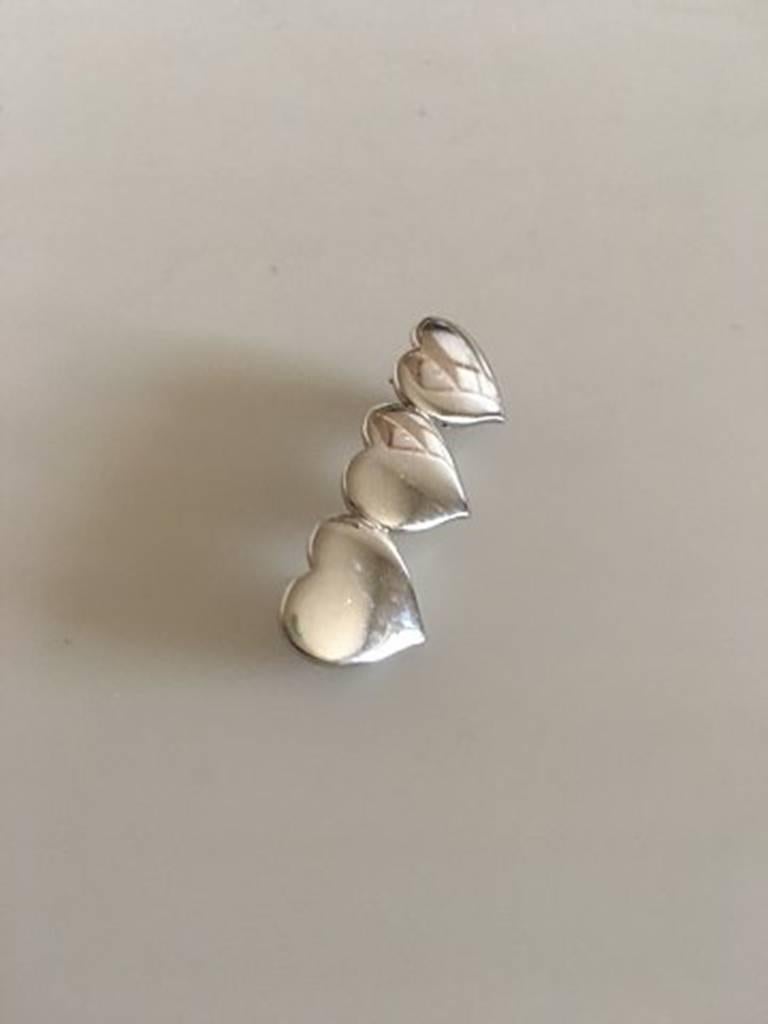 Hans Hansen Sterling Silver Brooch with Three Hearts. Measures 3.5 cm x 1 cm / 1 3/8 in. x 0 25/64 in. Weighs 4.9 g / 0.17 oz.