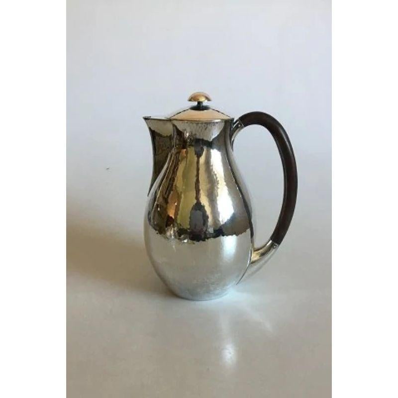 Hans Hansen Sterling Silver coffee set

Consists of Coffee Pot, Creamer and Sugar Bowl.
Handle made of wood. 

Coffee Pot 20.5 cm / 8 5/64 in., weighs 619 g / 21.85 oz. Creamer 11.5 cm / 4 17/32 in., weighs 222 g / 7.85 oz. Sugar Bowl 9 cm / 3