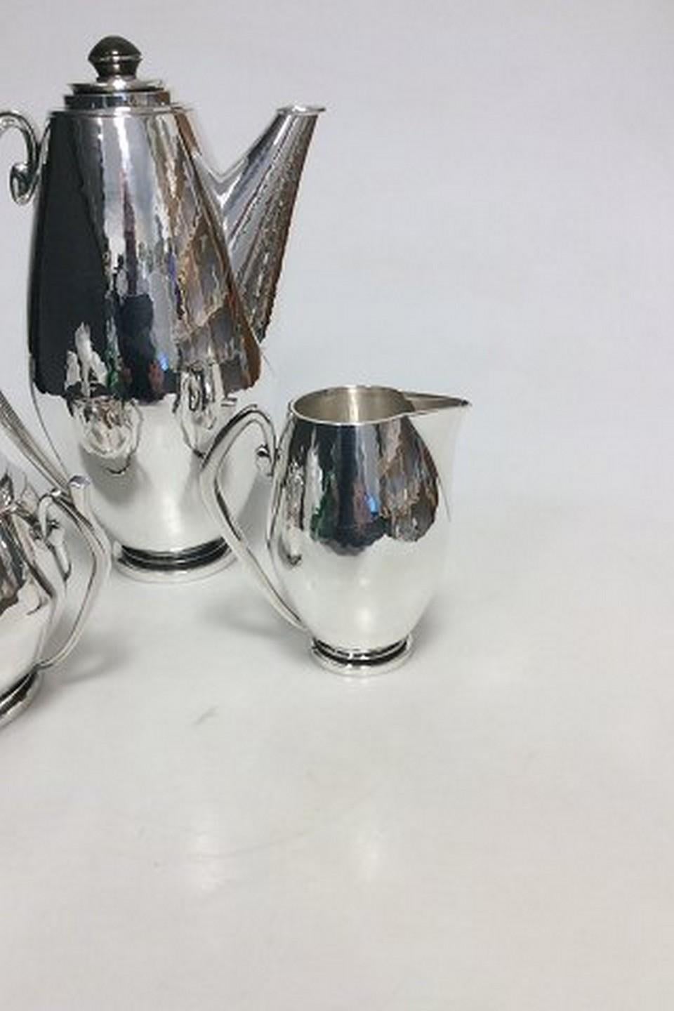 Hans Hansen Sterling Silver Coffee set with Coffee pot, creamer and sugar from 1935 by Karl Gustav Hansen.
Designed in 1934 and this produced in 1935.
Handle and bottoms are made of horn.

Measures: Coffee Pot 23,5cm high, Creamer 10,2cm and