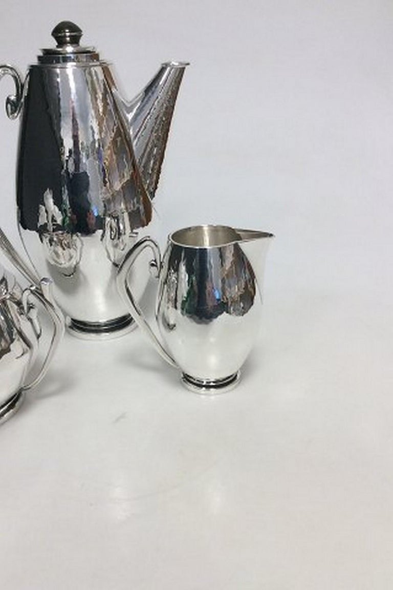 Hans Hansen Sterling Silver Coffee set with Coffee pot, creamer and sugar from 1935 by Karl Gustav Hansen.
Designed in 1934 and this produced in 1935.
Handle and bottoms are made of horn.

Measures: Coffee Pot 23,5cm high, Creamer 10,2cm and