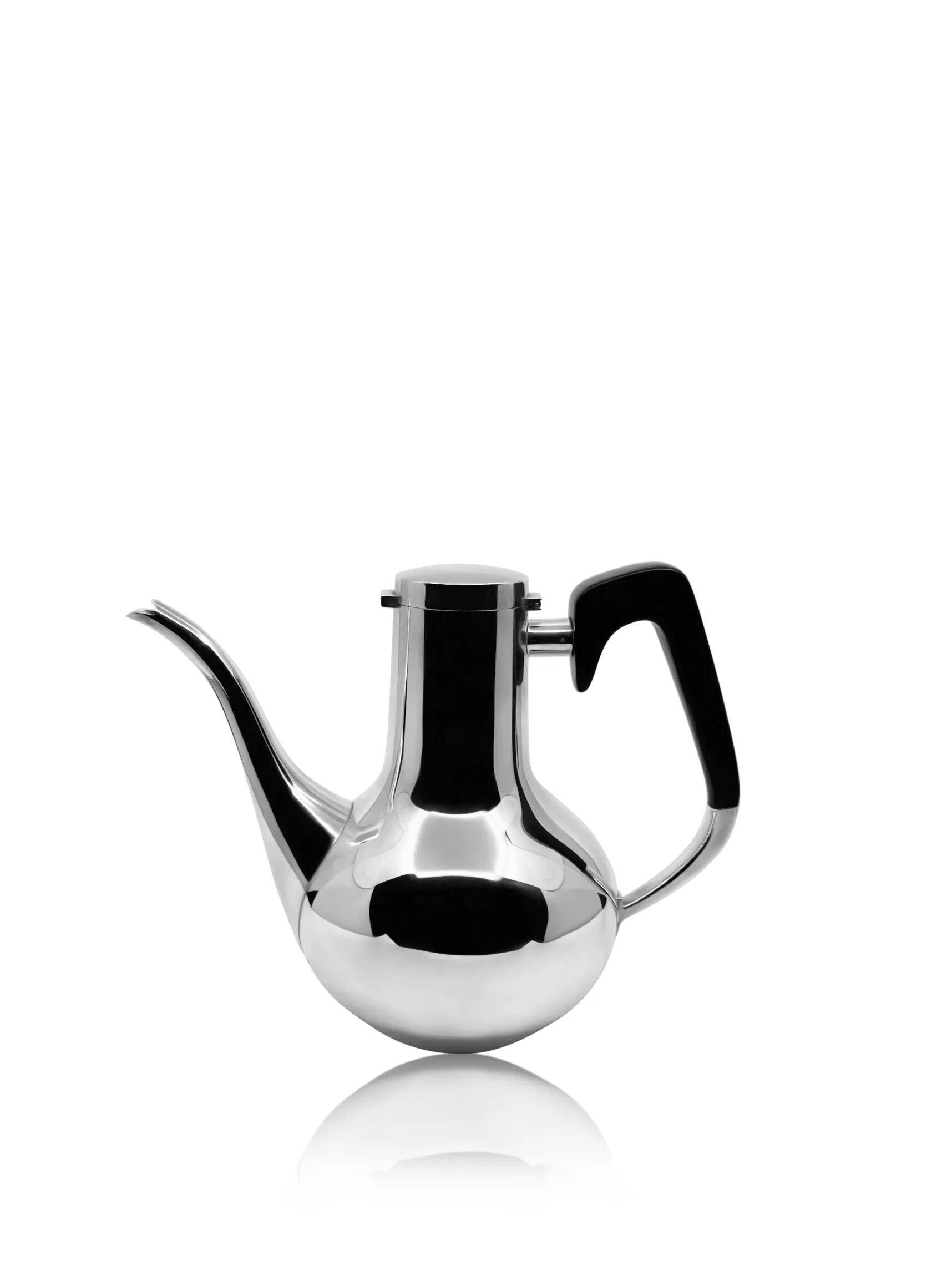 A Mid-Century sterling silver coffee pot, design #540 by Karl Gustav Hansen for Hans Hansen, created in 1966. This elegant, drop-shaped teapot features a long, conical neck and a hinged, domed lid. It is fitted with a curved spout and a ebony