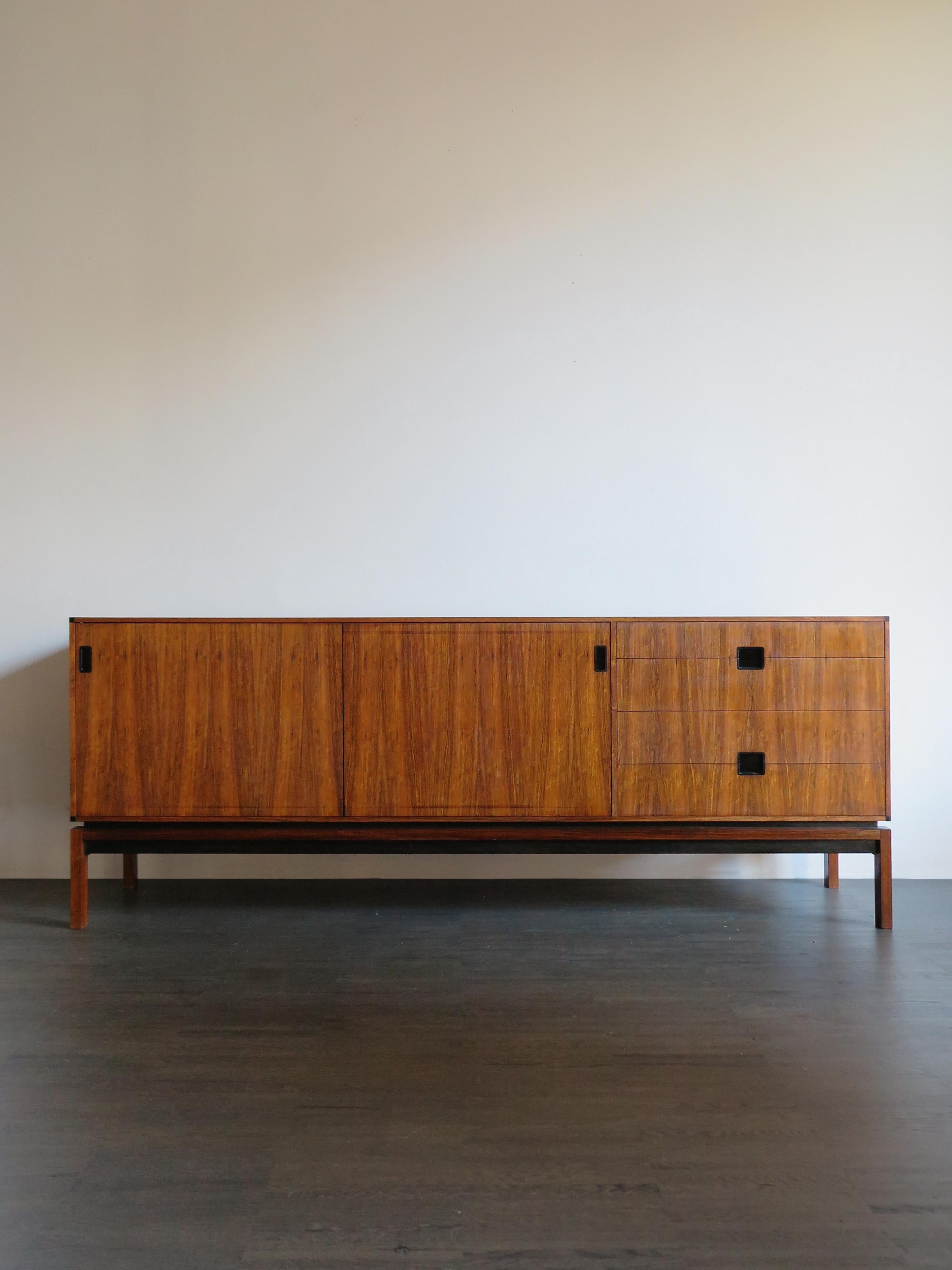 Scandinavian dark wood sideboard designed by danish designer Hans Hove & Palle Petersen with two sliding doors and four drawers, 1960s
Please note that the item is original of the period and this shows normal signs of age and use.