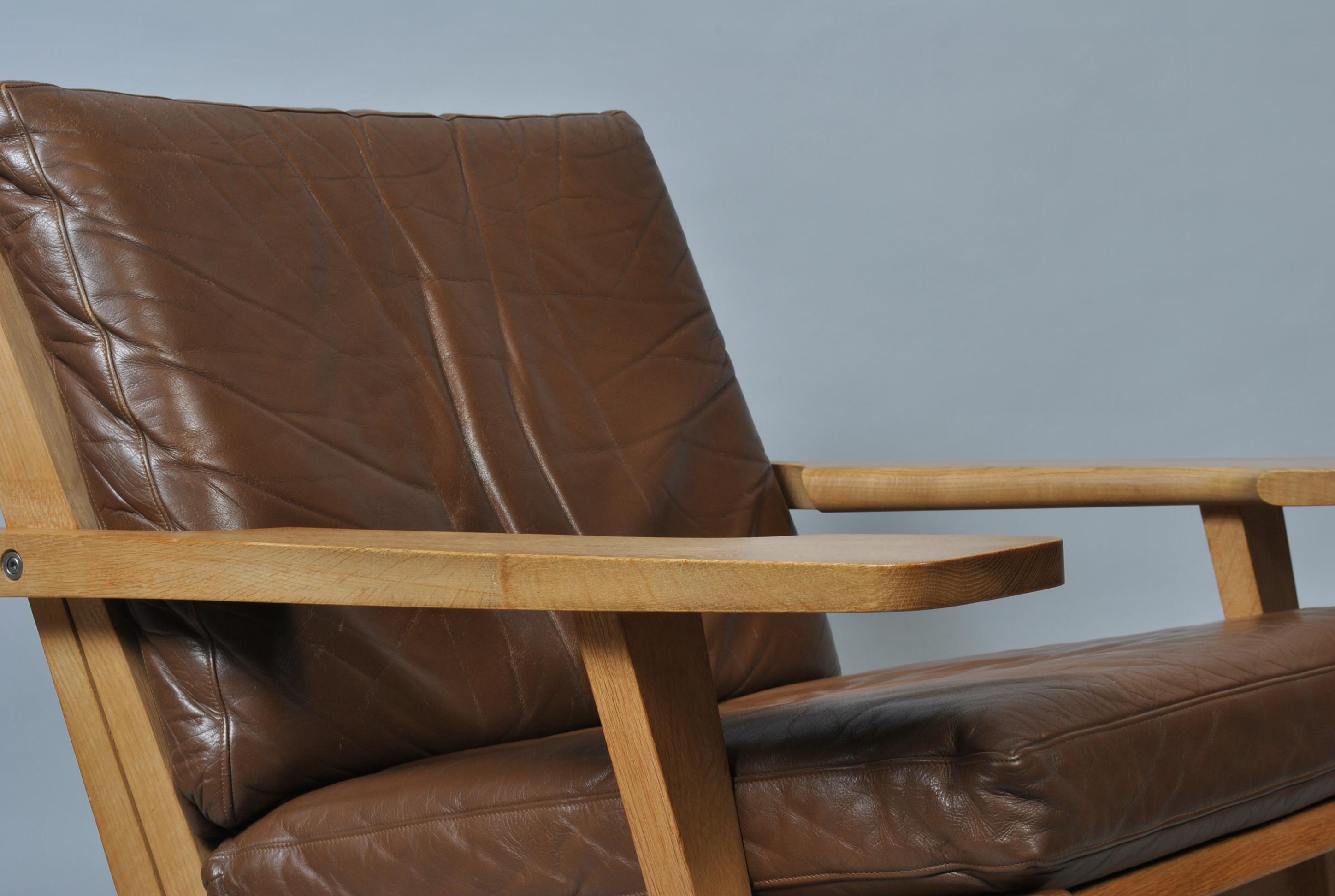 An impressive example of the Classic GE375 chair. Designed by Hans J Wegner for GETAMA, Denmark, 1960s. Lovely golden European oak frame with original mid brown leather upholstery. Custom re-upholstery is available upon request. Substantial curved