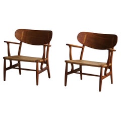 Hans J. Wegner, A Pair of CH22 Lounge Chairs in Oak, Danish Modern, 1950s