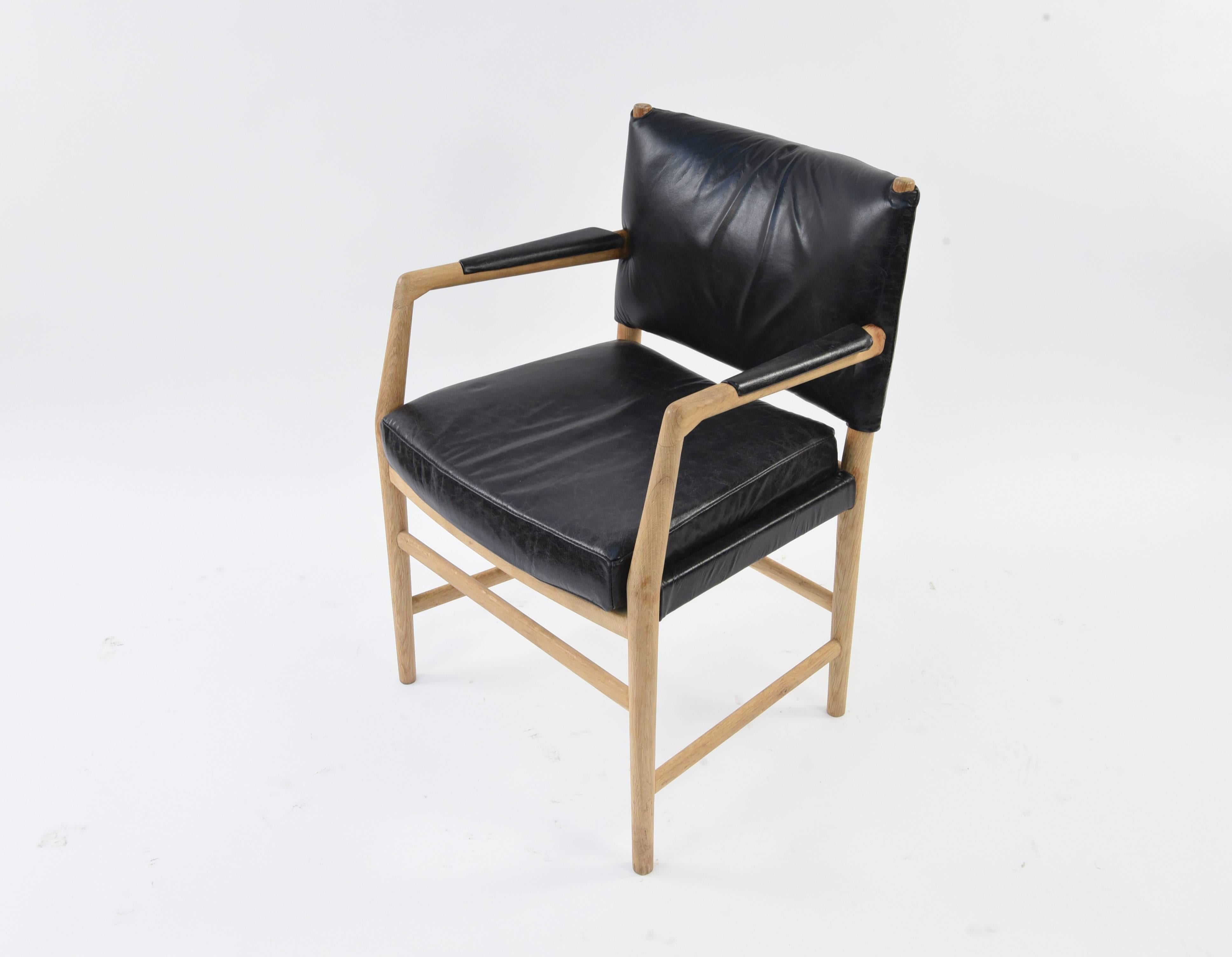 'Aarhus city hall chair', in oak and leather, by Hans J. Wegner for Plan Møbler, Denmark, 1942. Designed for the Aarhus city hall in Denmark. Wonderful design with black leather upholstery on the seats and back, with great detail of upholstered arms.