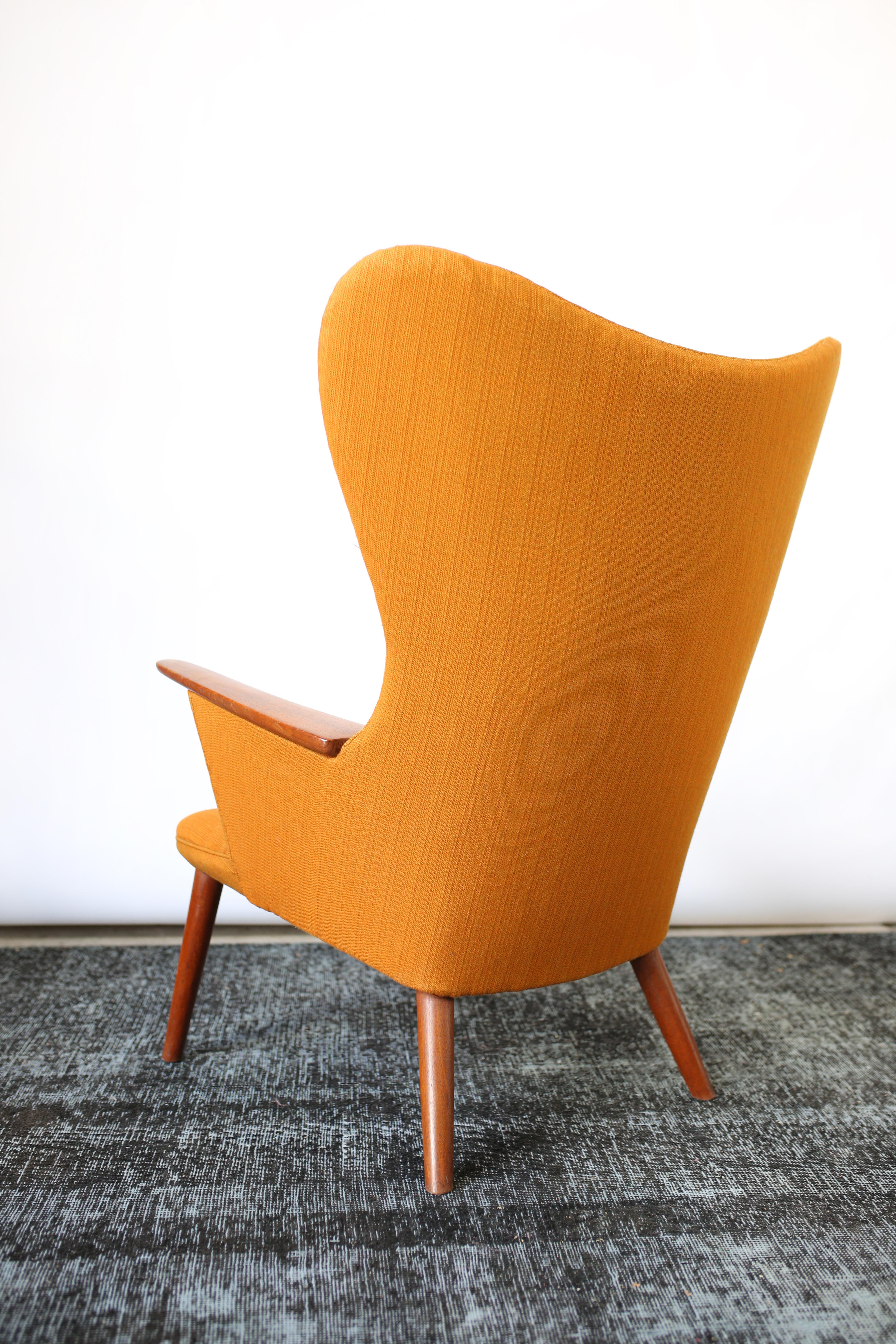 Modern teak AP 28 'Mama Bear' lounge chair by Hans J. Wegner for AP Stolen, 1954
Original orange upholstery
Teak frame
Danish modern design
Measures: H 42.92 in. x W 33.86 in. x D 27.56 in.