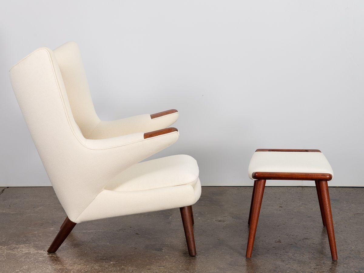 Original 1960s AP-19 Lounge Chair, better known as the Papa Bear Chair, designed by Hans J. Wegner for A.P. Stolen. A magnificent example of the iconic lounge chair. Our chair has carefully polished teak paws and matching ottoman upholstered . Both