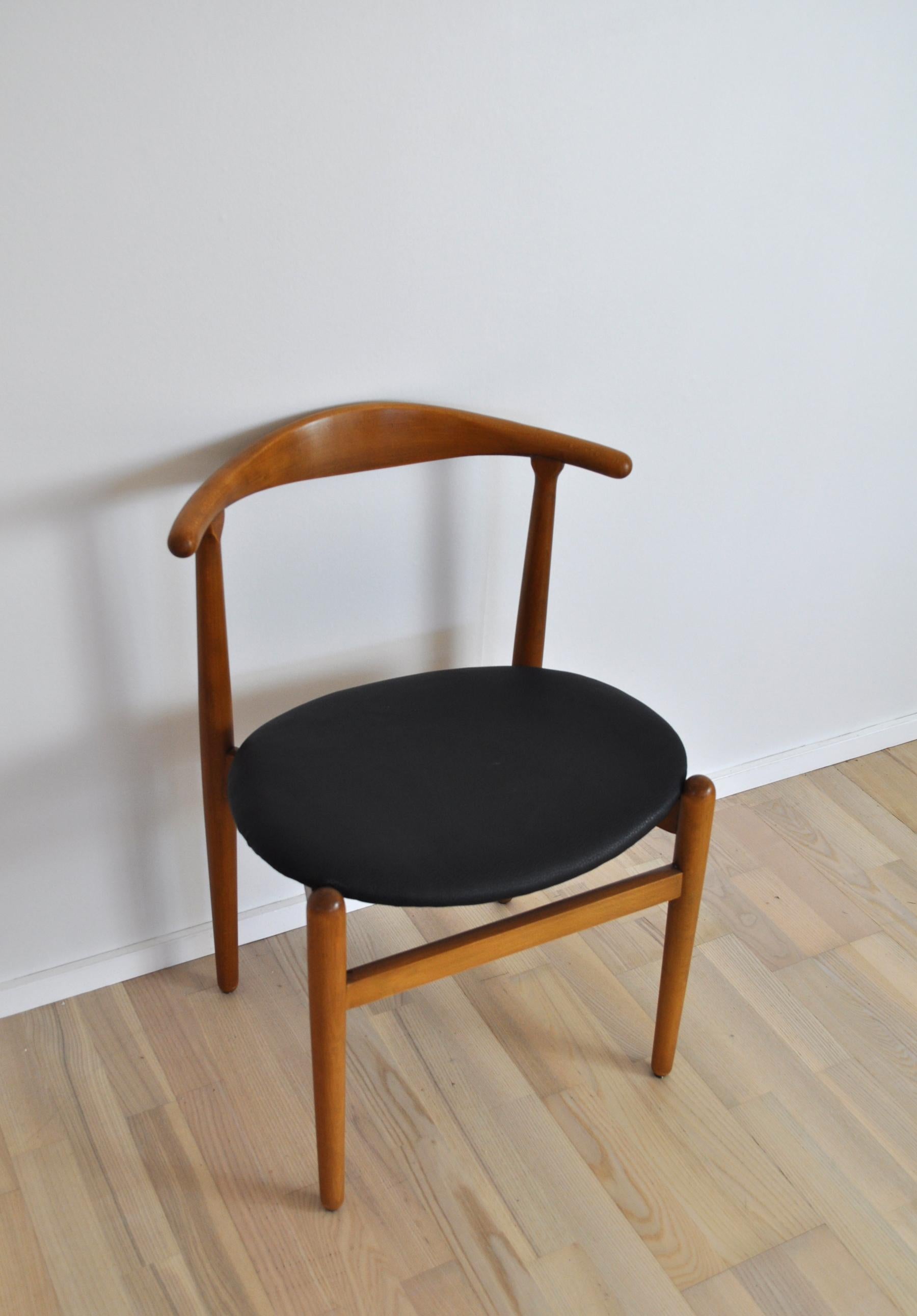 Solid beech armchair, newly upholstered in black faux leather. Design by Hans J. Wegner. Produced by Fritz Hansen. Designed in 1948, model no. 708 (not in production).
