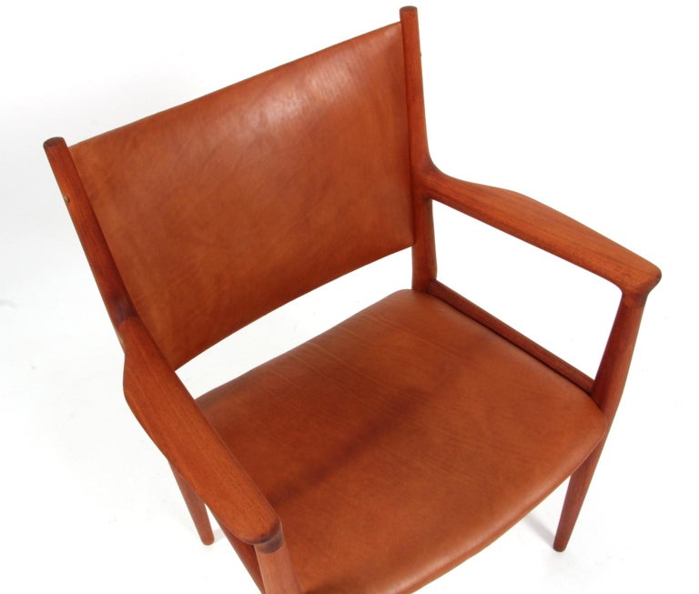 Hans J. Wegner armchair new upholstered with cognac aniline leather.

Made of solid mahogany.

Model JH513, made by Johannes Hansen.