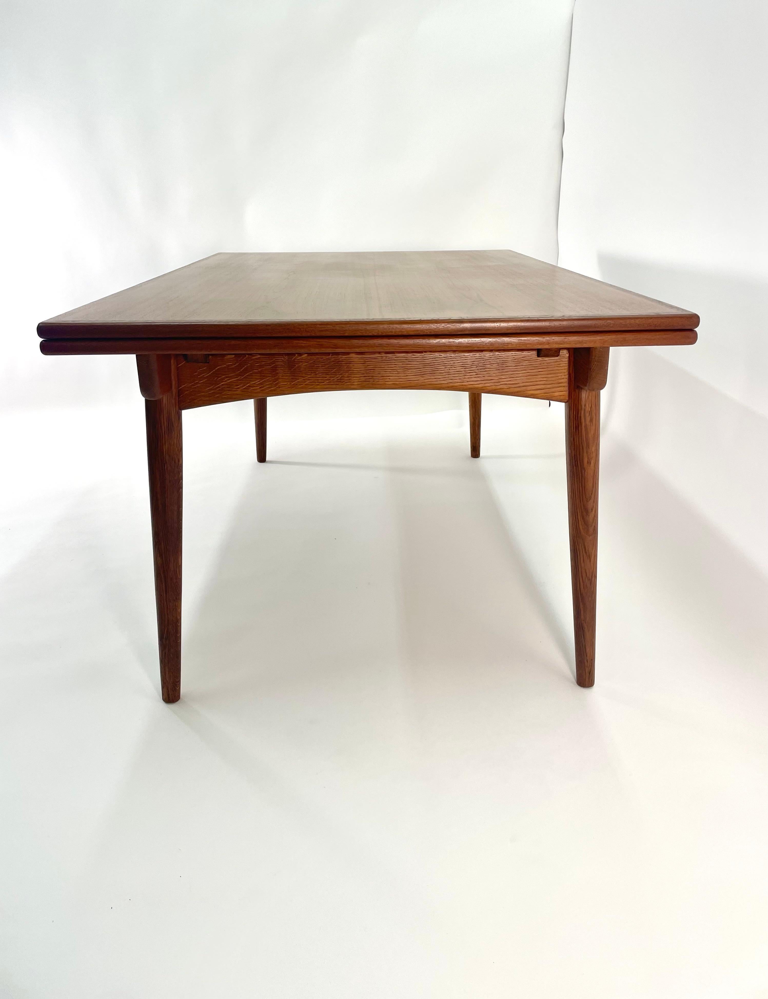 Hans Wegner  AT-312 Sculpted Teak & Oak Dining for Andreas Tuck. Made in Denmark, Large draw leaf dining table. Leaves conveniently store under the table when not in use and easily pull out when needed. This table is very wide compared to most
