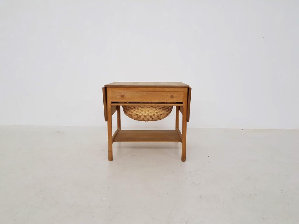 Hans J. Wegner “AT33 / PP33” sewing table for PP Møbler from Denmark 1953

The famous sewing table by the yet more famous Danish top designer Hans Wegner. The sewing table is made of ash and has two extensions leaves, a drawer and a woven rattan