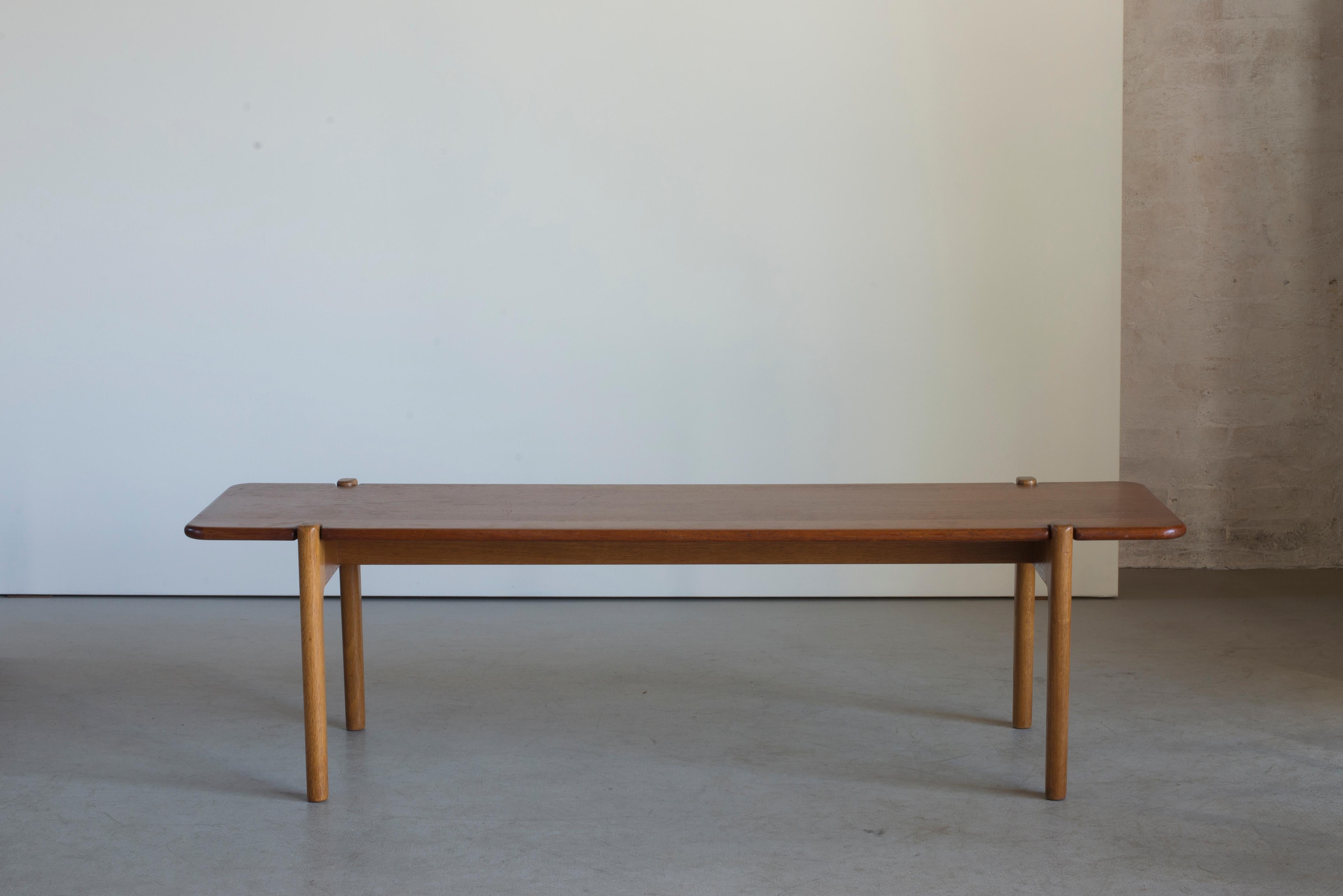 Bench or occasional table by Hans J. Wegner. Executed by Johannes Hansen, Denmark.

Oak and teak.