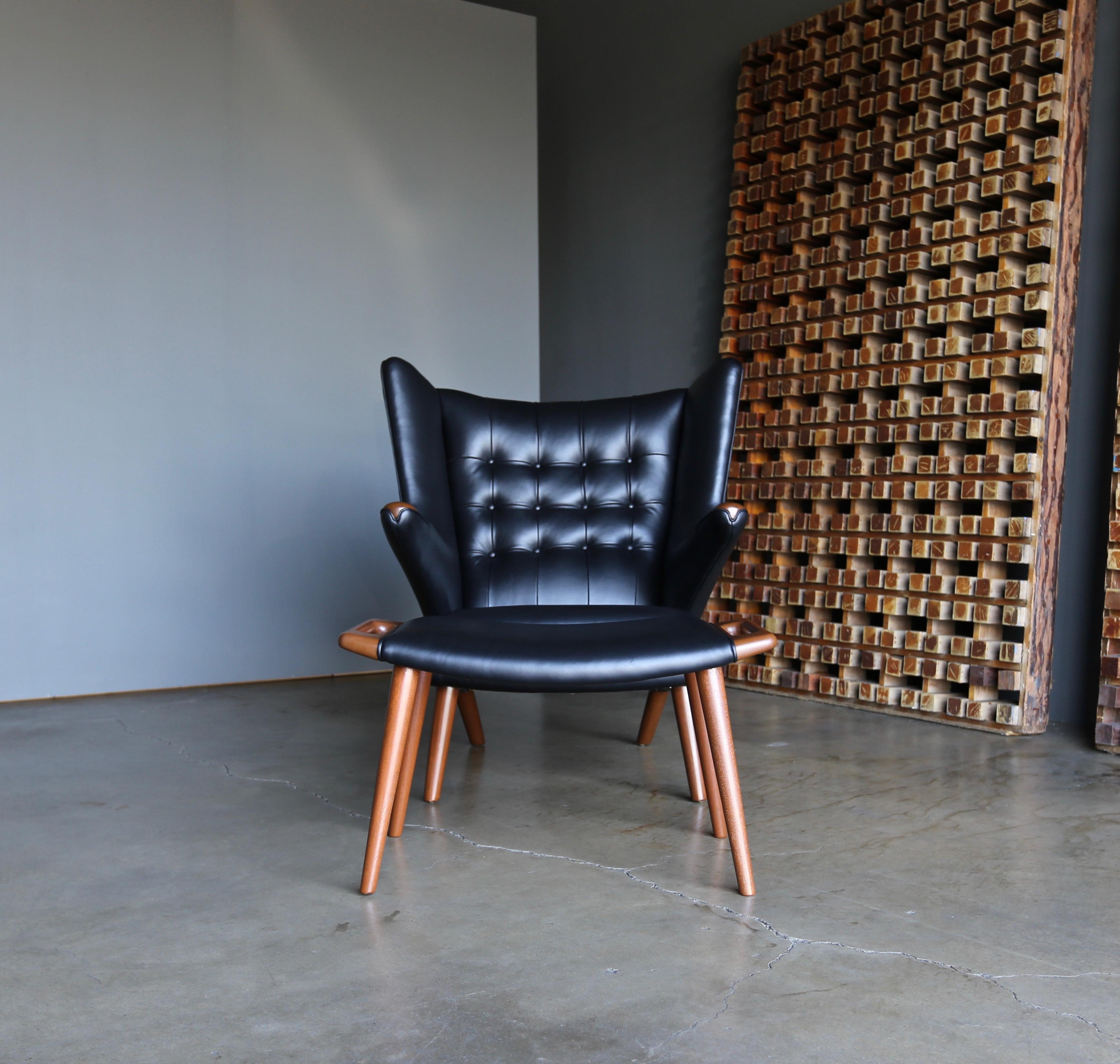 Hans J. Wegner black leather Papa Bear chair and ottoman for A.P. Stolen circa 1950. This piece has been professionally restored. 

Faint makers mark to the ottoman. Quality assurance inspector #30 to the bottom of the chair. 

 