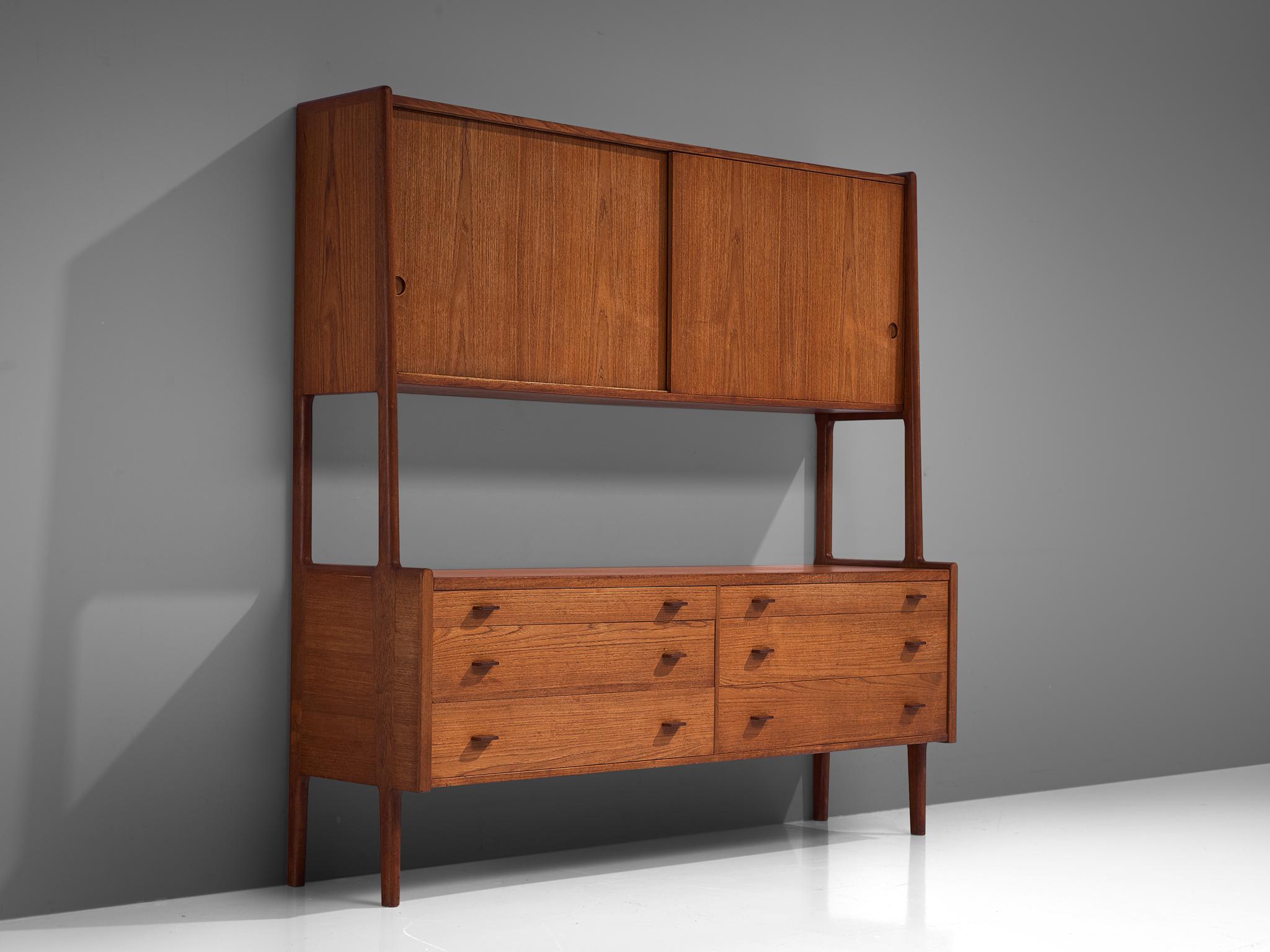 Hans Wegner for Ry Møbler, cabinet RY20, teak, Denmark, 1950s.

This cabinet is executed in teak and is typical for midcentury Scandinavian design. The cabinet features a base with four cylindrical legs that function as connective elements for the