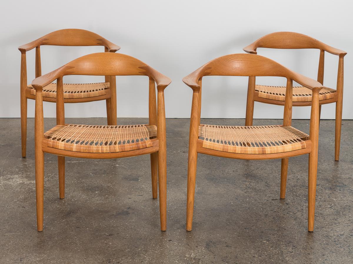 Set of four matching Model JH 501 dining chairs with cane seats, designed by Hans Wegner for Johannes Hansen, Denmark. This iconic design is best known as 