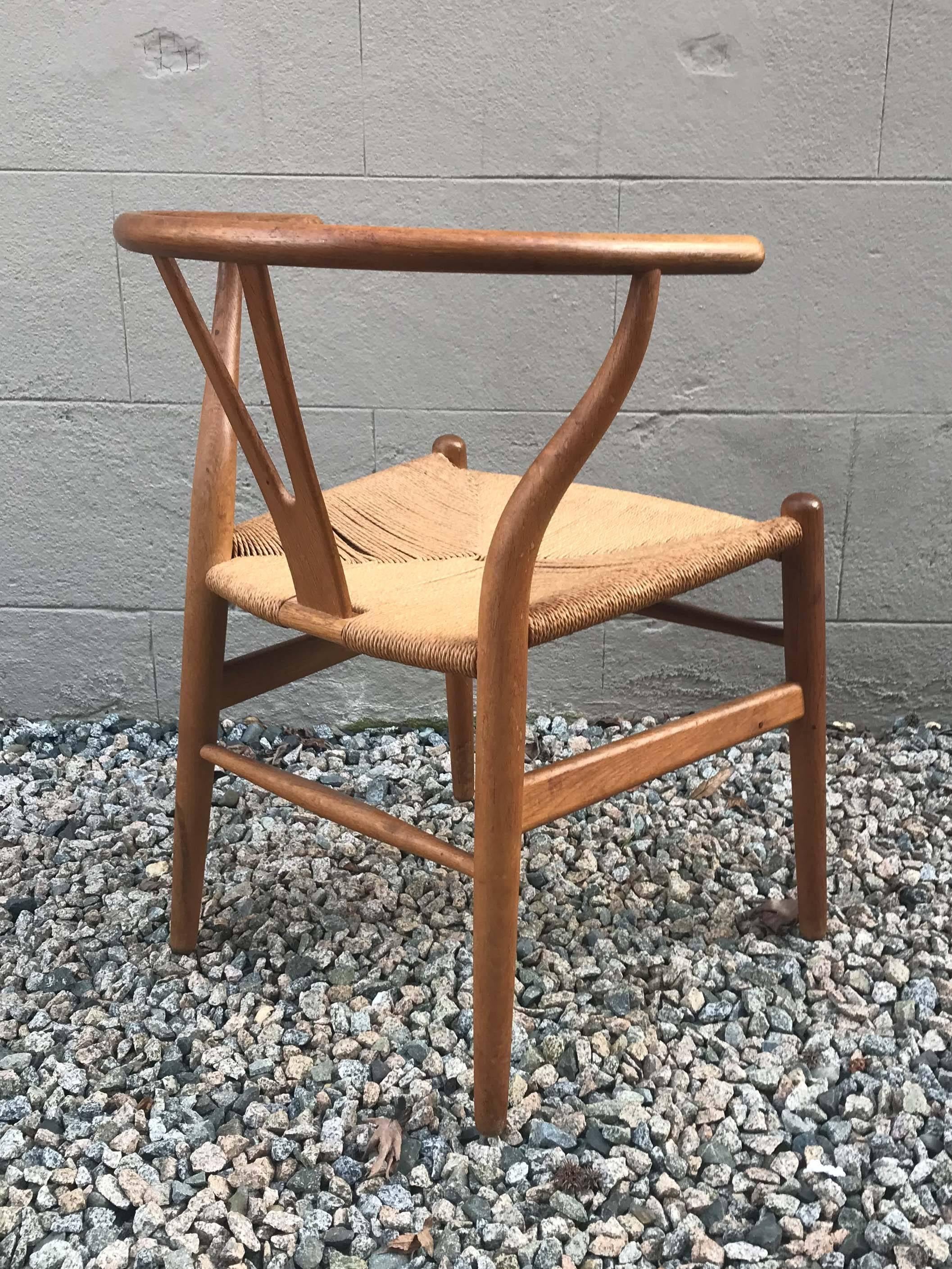 A set of six Hans J. Wegner CH-24 wishbone chairs in oak with woven cord seats. Very good vintage condition, minor wear consistent with age and use. Please note the minor spotting on the cord seats. Stamped with original labels attached to bottom.