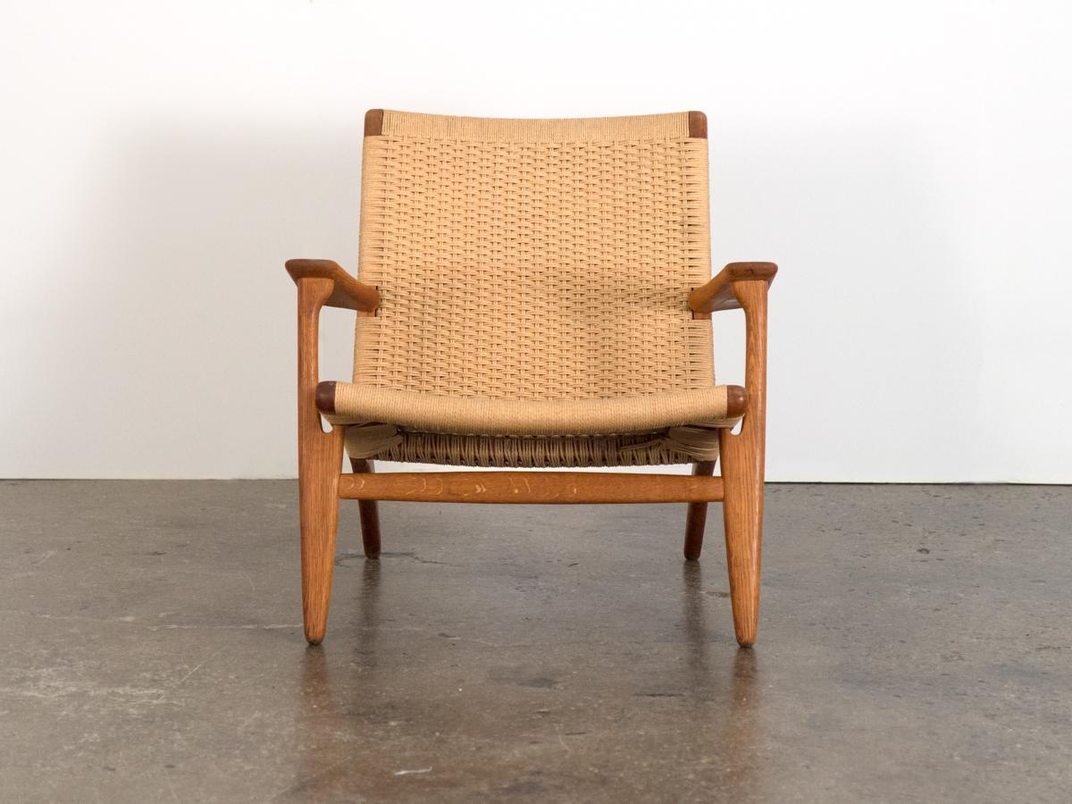 Spectacular Hans J. Wegner Ch-25 armchair designed in 1951 for Carl Hansen & Son. An exceedingly comfortable, solid lounge chair. This design is characterized by the reclining silhouette and handwoven paper cord seats and back. Wide and sturdy