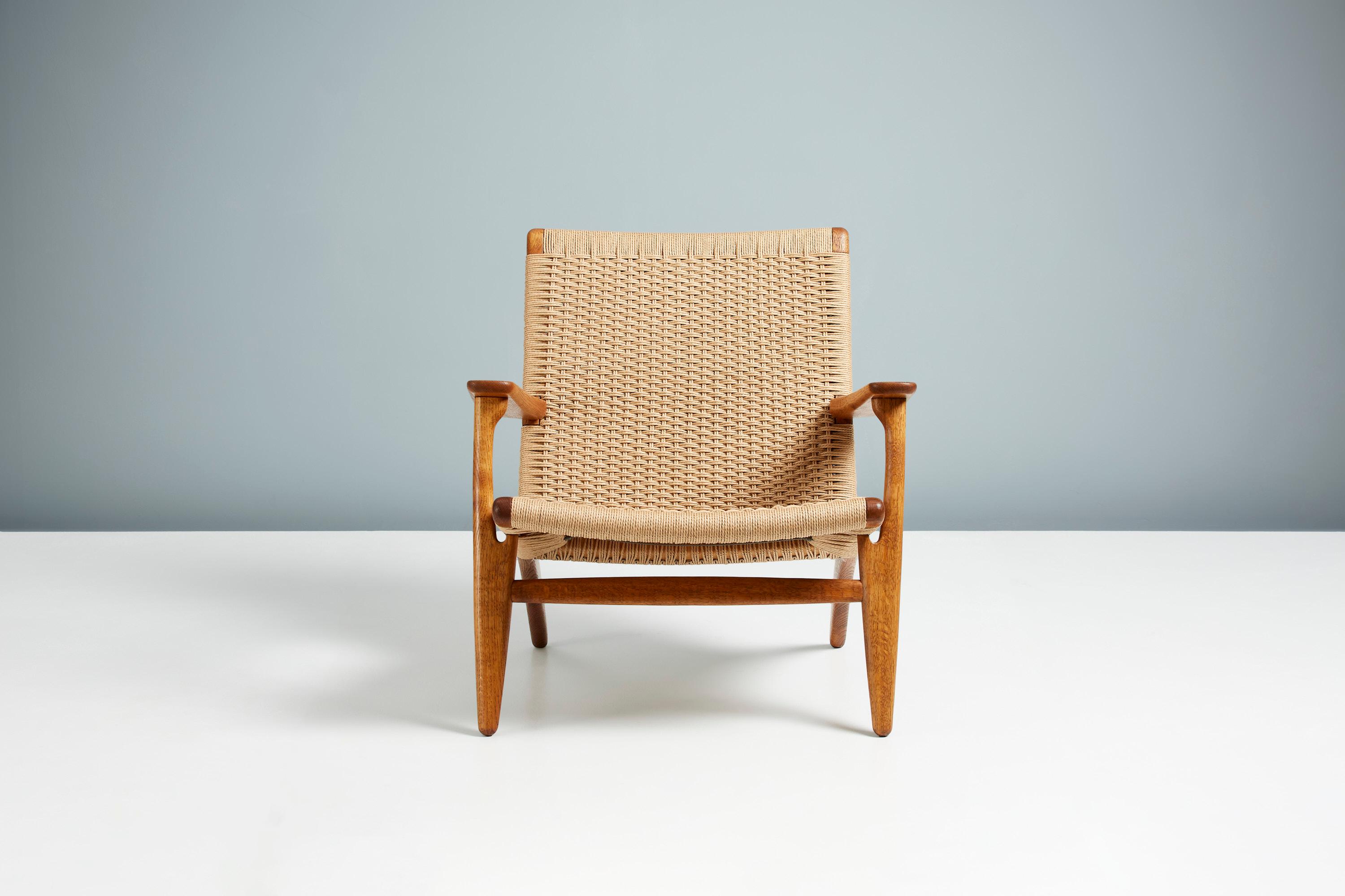 Hans J. Wegner

CH-25 lounge chair, 1950

Produced by Carl Hansen & Son, Copenhagen, Denmark. Oiled, patinated oak frame with new woven paper cord seat and back. 

This is an early example of this iconic design in fantastic condition.