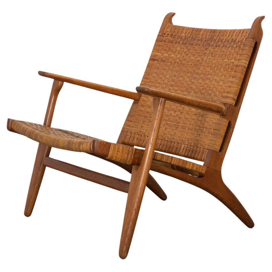 Hans J. Wegner CH-27 Oak Lounge Chair with Woven Rattan Seat For Sale