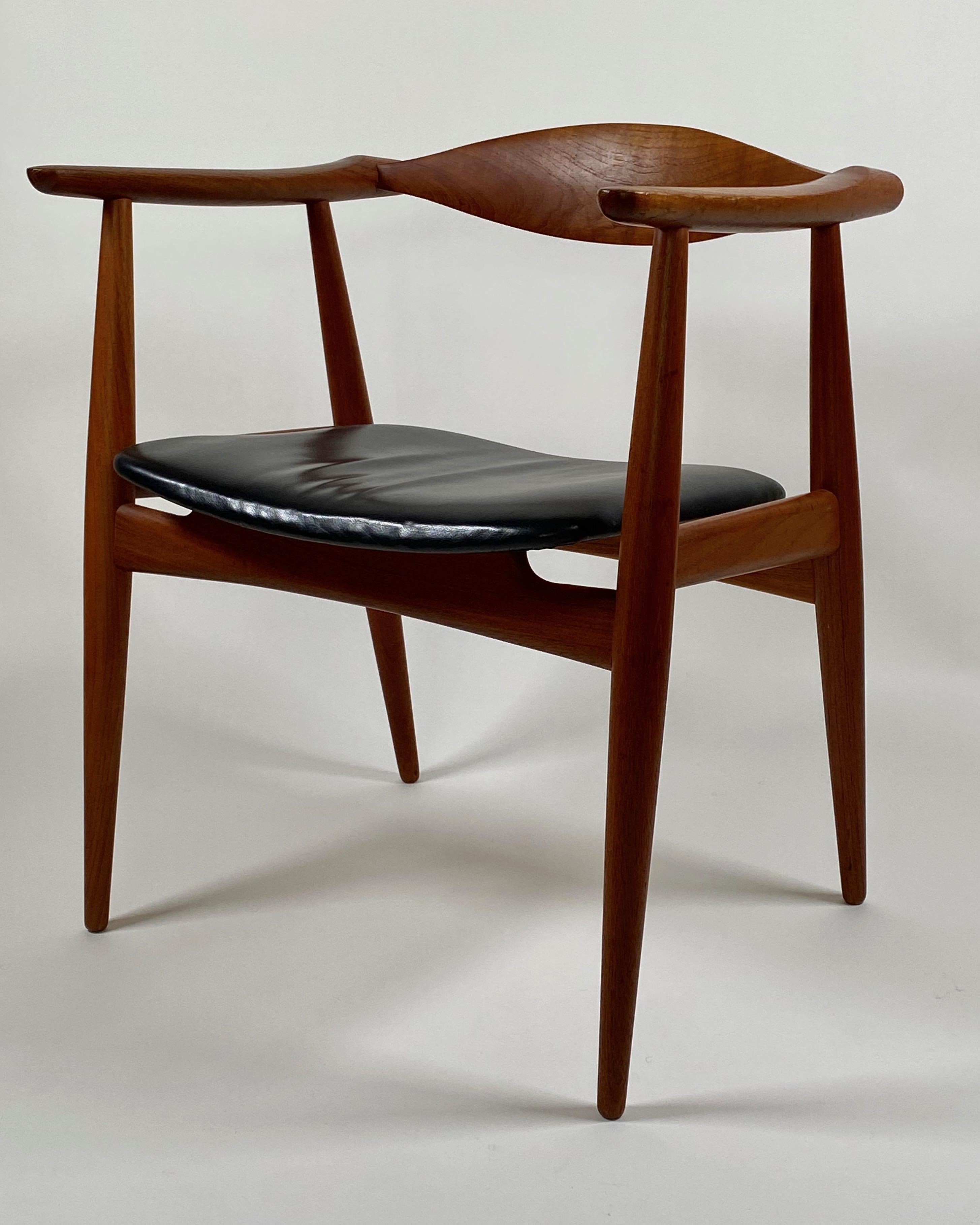 CH 35 teak armchair / dinning chair by Han J Wegner for Carl Hanson & Son circa late 1950s Denmark.. These chairs were produced in low numbers in teak and are a rarity to find, this with its black leather upholstered seat is in all original