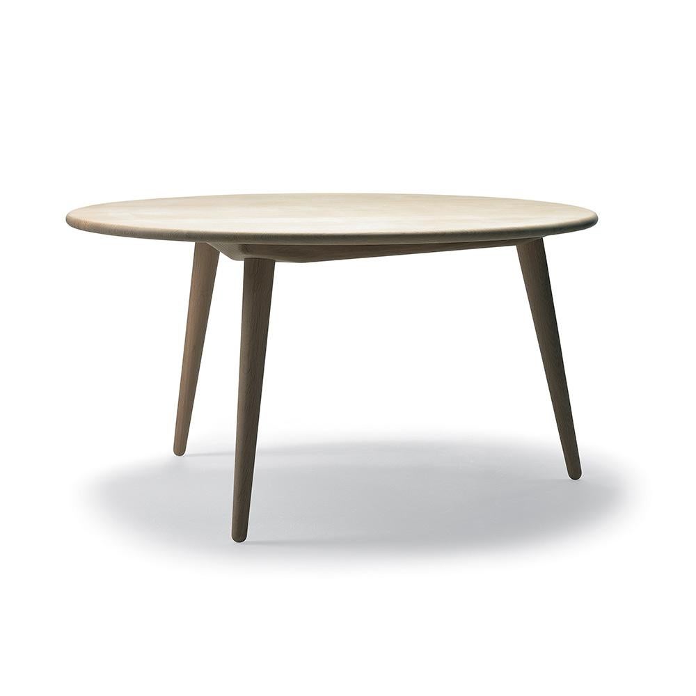 CH008 se compose d'un plateau rond et de trois pieds amovibles et effilés qui s'inclinent vers l'extérieur. Les pieds arrondis donnent à la table basse une allure élégante et presque flottante. La table est soutenue par un solide cadre triangulaire