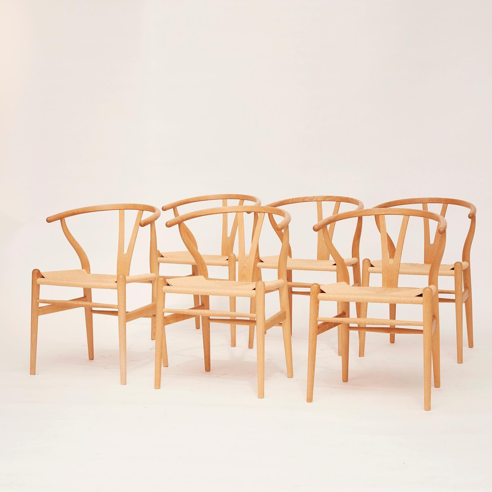 6 Hans J. Wegner CH24 Wishbone chairs, Y-chairs. Designed 1950, manufactured by Carl Rasmusen Oak / woven paper cord. As new 8 - 10 years old. Never used.