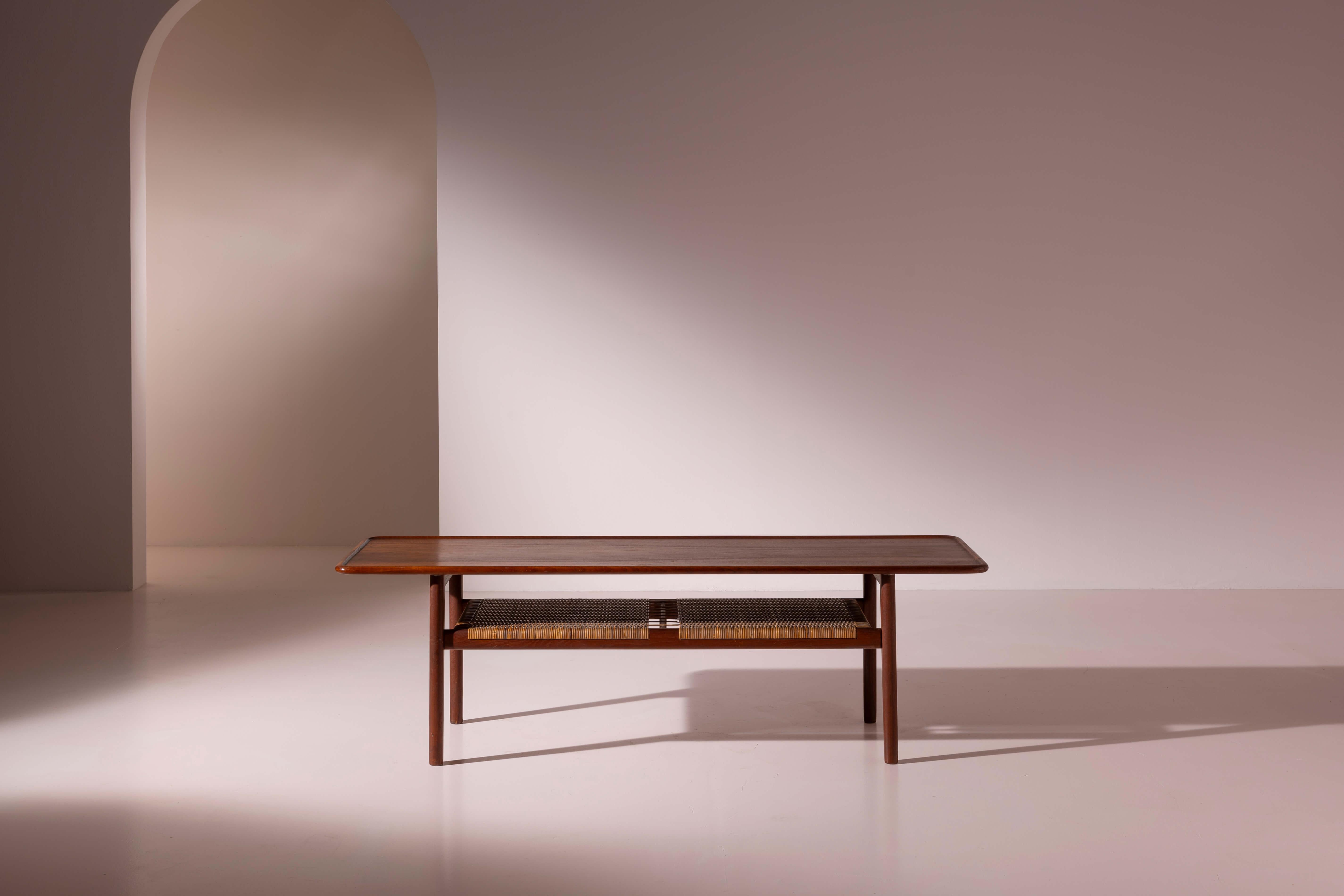 A teak and woven cane coffee table, danish manufacture, Andreas Tuck, design by Hans Wegner, 1950s

The clean, organic lines of Scandinavian furniture have left an indelible mark on the history of 20th-century design. The use of finely finished wood