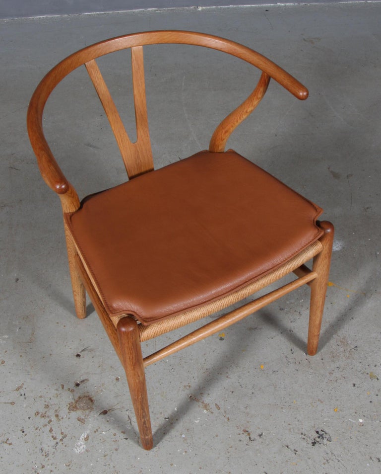 Hans J. Wegner cushions for wishbone chair model CH24.

Made in cognac pure aniline leather and good quality foam.

Only the cushion, not the chair.