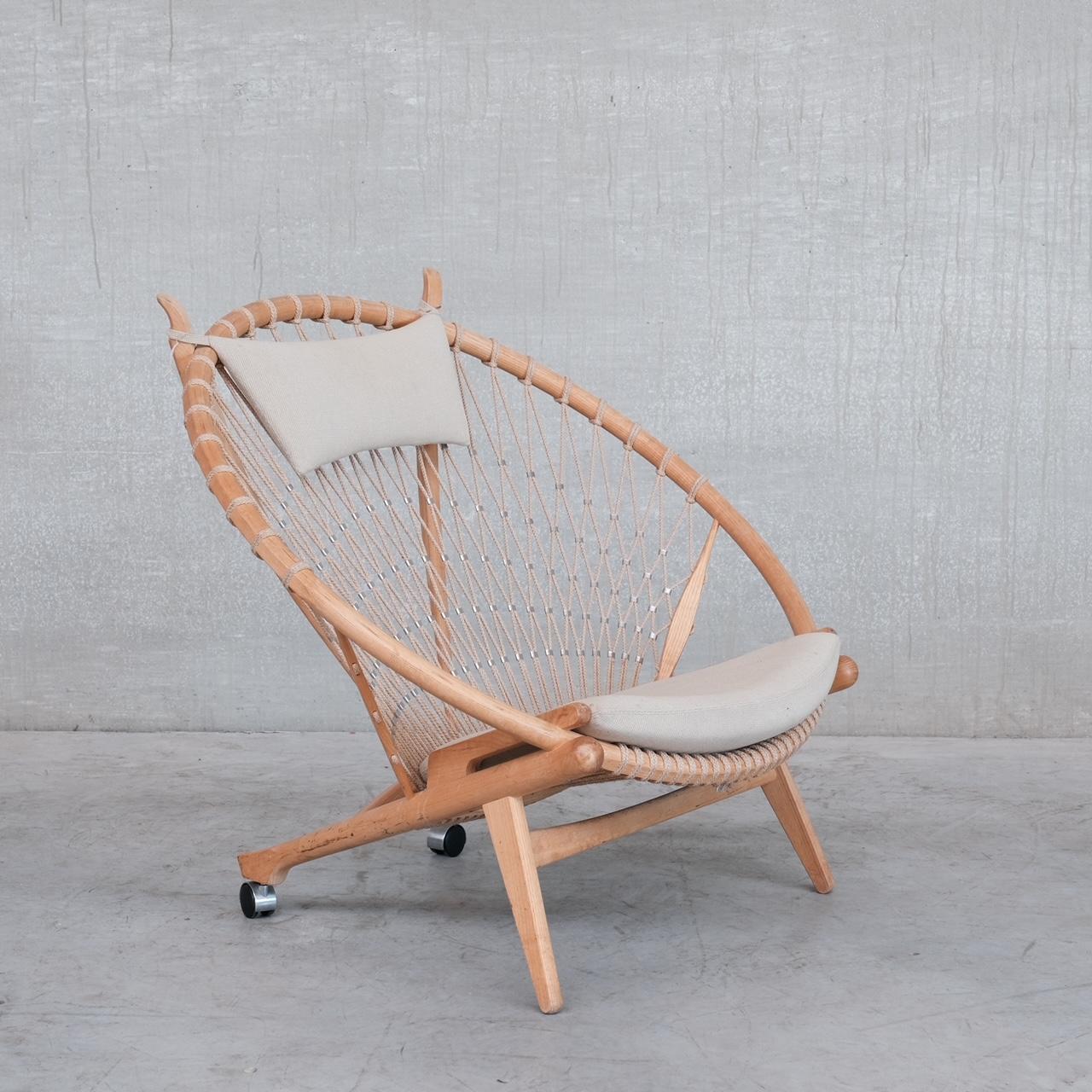 A scarce mid-century open lounge chair by Hans J Wegner. 

Circle chair for PP mobler. 

Denmark, c1980s. 

Suprisingly comfy, the original upholstery has been retained but has some stains, it can easily be updated. Some scuffs and wear