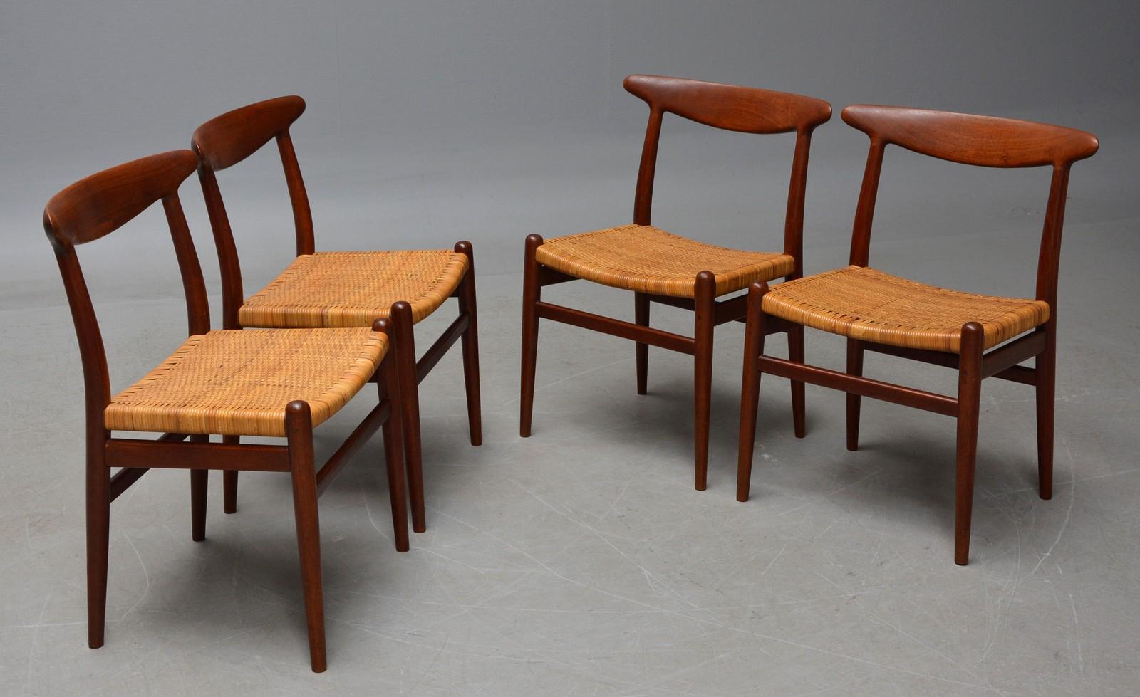 Hans J. Wegner 1914-2007. A set of four teak chairs and patinated wicker. Produced by C.M. Madsen 1960s with stamp from here. Model W2, Rare offered model. Well-maintained with minimal traces of use age taken into account.