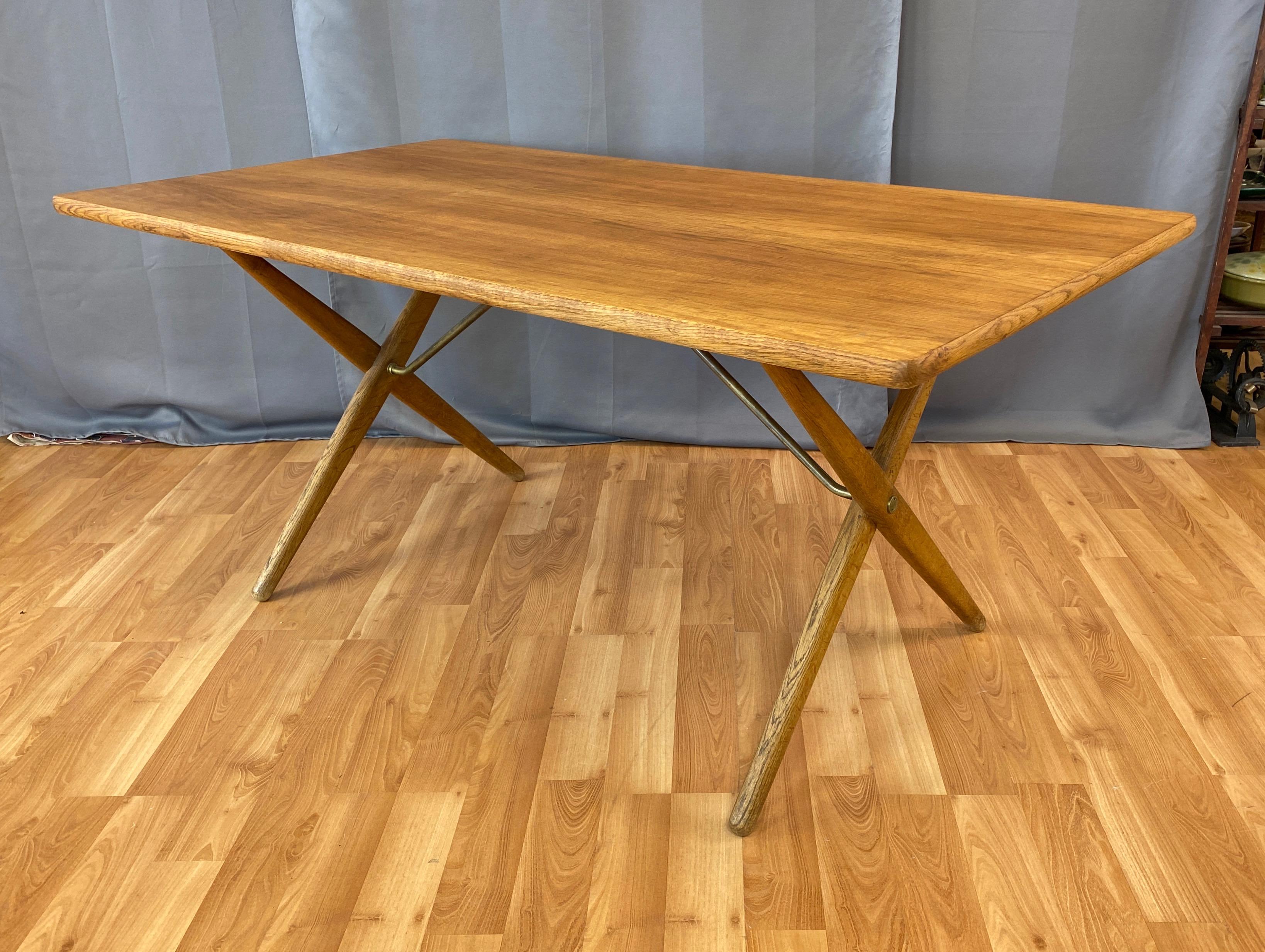 An AT-303 cross-leg oak dining table designed in 1955 by Hans J. Wegner and produced by Andreas Tuck.

Commonly referred to as the “Sawhorse” table, this iconic Wegner piece features distinctive X-shaped solid oak legs with a handsomely figured