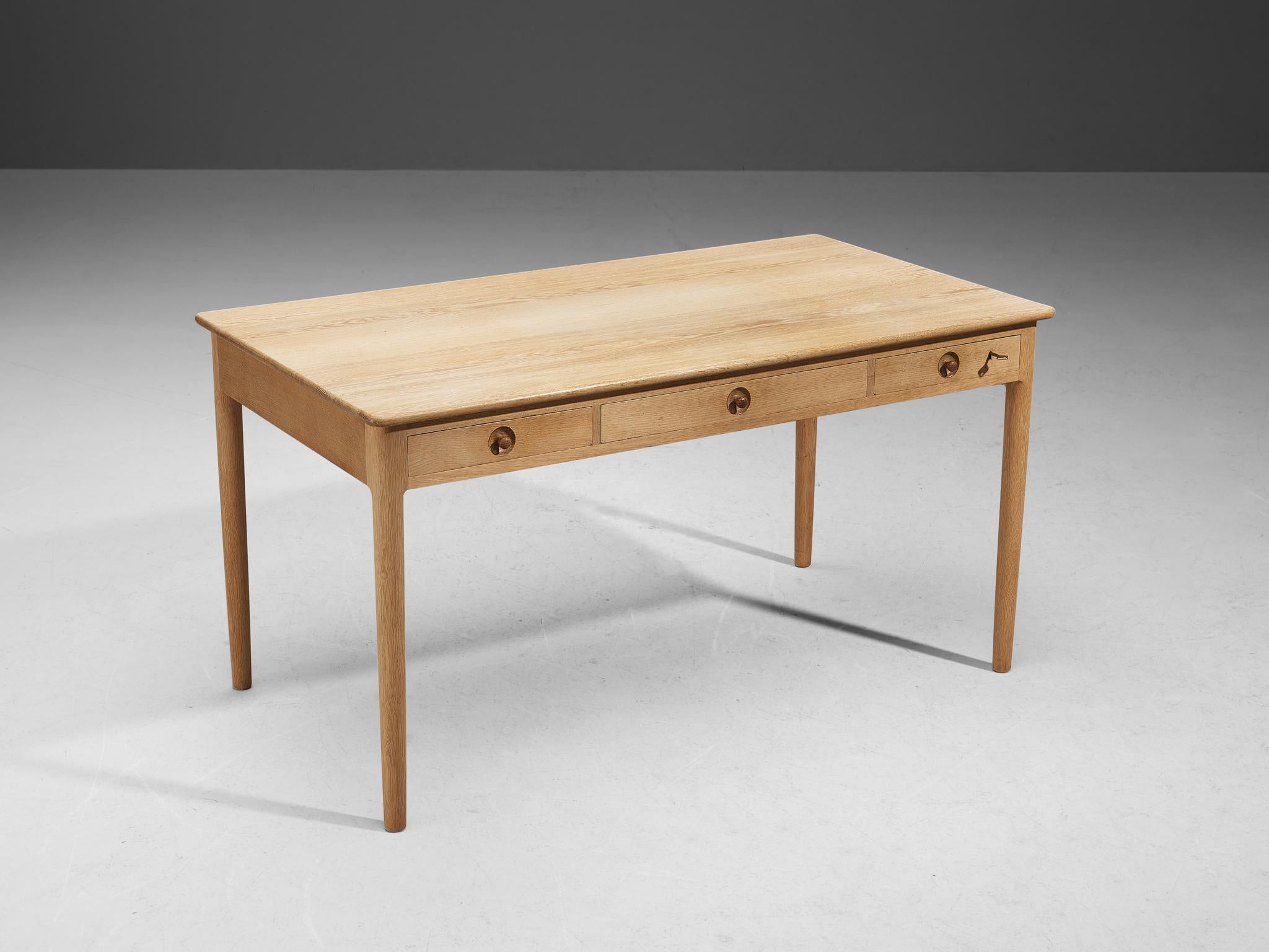 Hans J. Wegner for Andreas Tuck, 'AT 305' desk, oak, Denmark, design 1953

Elegant and slim desk designed by Hans Wegner and constructed by Andreas Tuck in the 1970s. The wood used to manufacture this desk is a stunningly fresh and beautiful oak