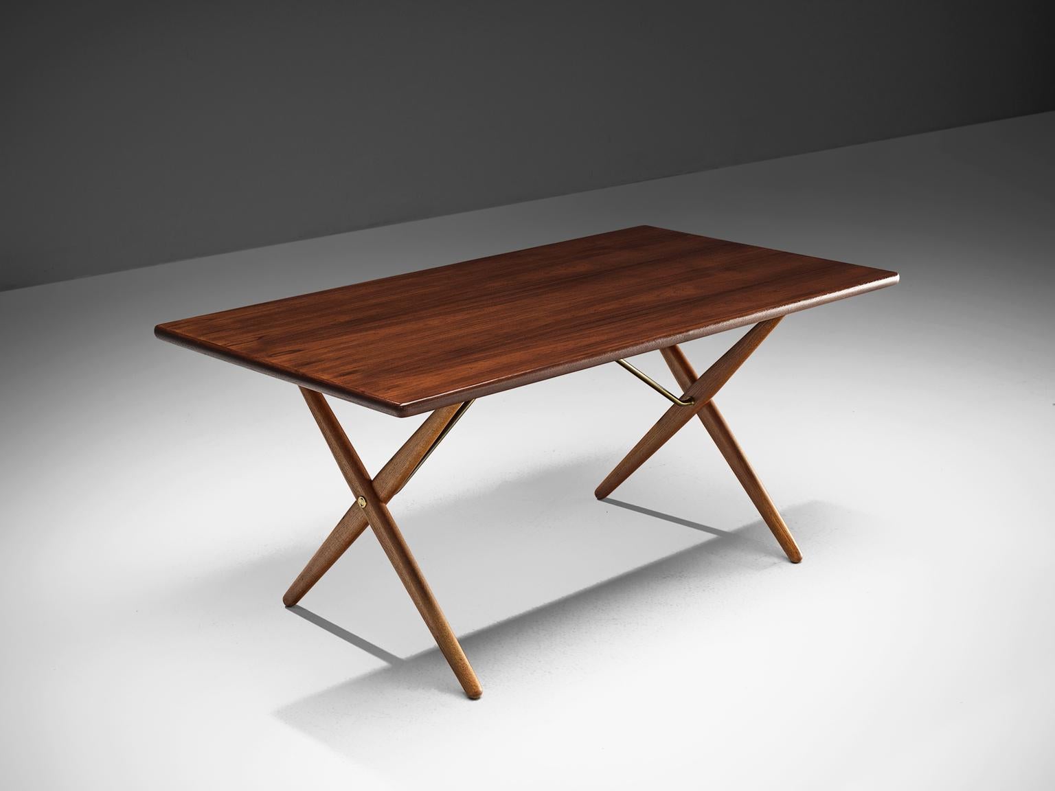 Hans J. Wegner for Andreas Tuck, table model AT-303, teak, oak and metal, Denmark, 1955.

Dining table with elegant X-shaped legs by Hans Wegner. This table is considered as one of the best known designs from Wenger. From a distance, this table,
