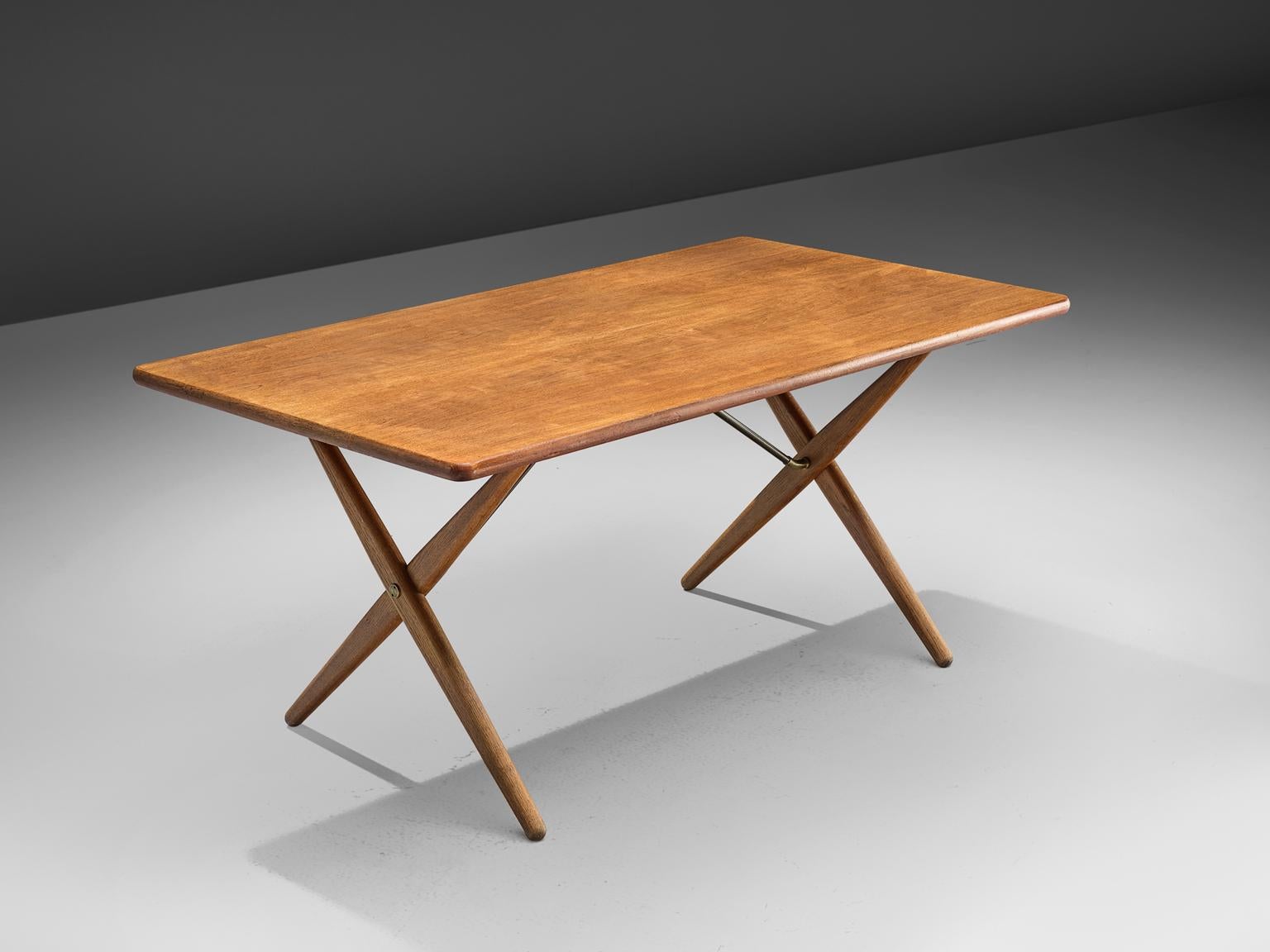 Hans J. Wegner for Andreas Tuck, table model AT-303, in teak, oak and metal, Denmark, 1955. 

Dining table with elegant X-shaped legs, by Danish Designer Hans Wegner. This table is considered as one of the best known designs from Wegner. From a