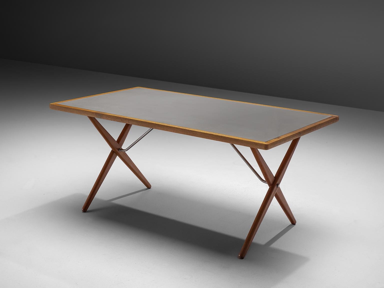 Hans J. Wegner for Andreas Tuck, table model AT-303, in teak, oak and metal, Denmark, 1955. 

Dining table with elegant X-shaped legs, by Danish Designer Hans Wegner. This table is considered as one of the best known designs from Wegner. From a