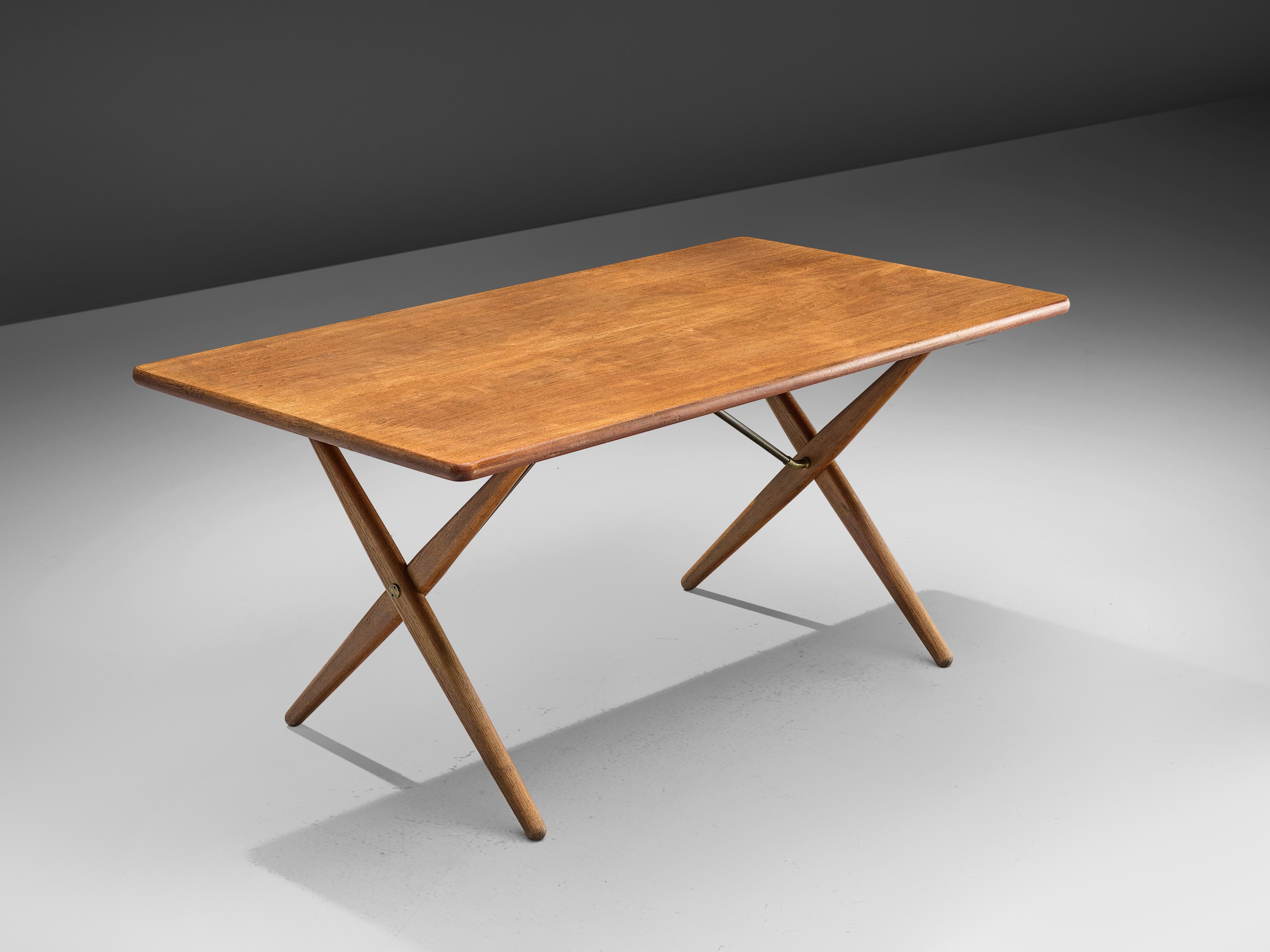 Hans J. Wegner for Andreas Tuck, table model AT-303, in teak, oak and metal, Denmark, 1955. 

Dining table with elegant X-shaped legs, by Danish Designer Hans Wegner. This table is a well-known design from Wegner. From a distance, this table, like