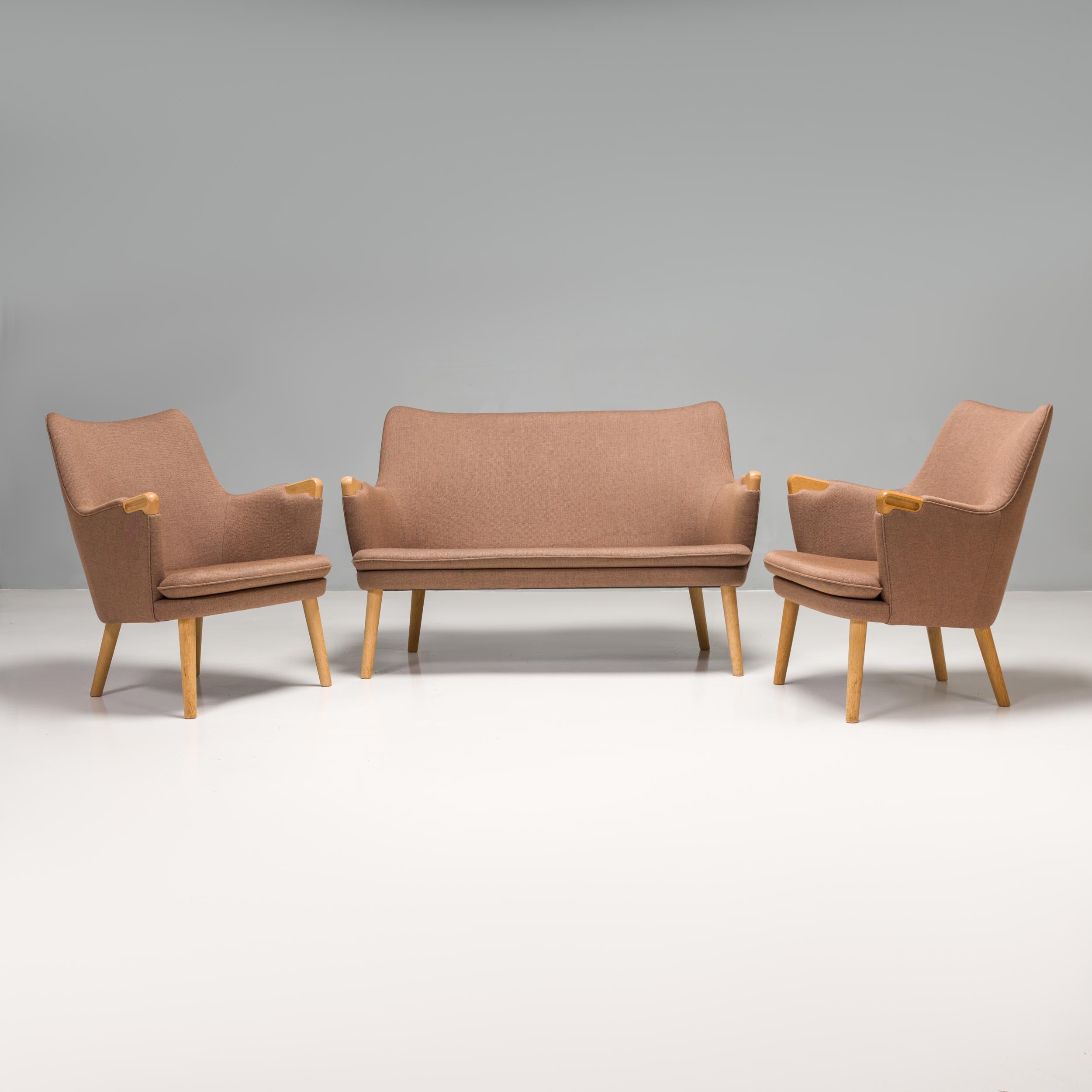Originally designed by Hans J. Wegner in 1952 for the Magasin du Nord store in Copenhagen, this CH72 sofa and CH71 armchair set is manufactured by Carl Hansen & Son and is a fantastic example of mid-century Scandinavian design.

Combining both