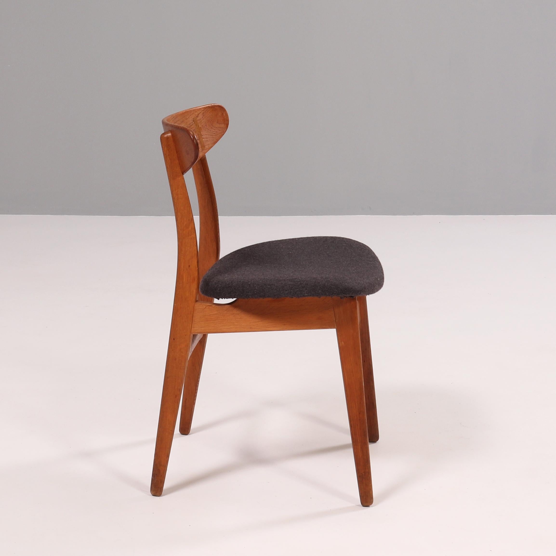 Originally designed by Hans J. Wegner in 1954, the CH30P chair showcases the designers signature style.

Constructed from solid wood, the dining chair features a curved oval backrest with cruciform cover caps, while the seat is upholstered in dark