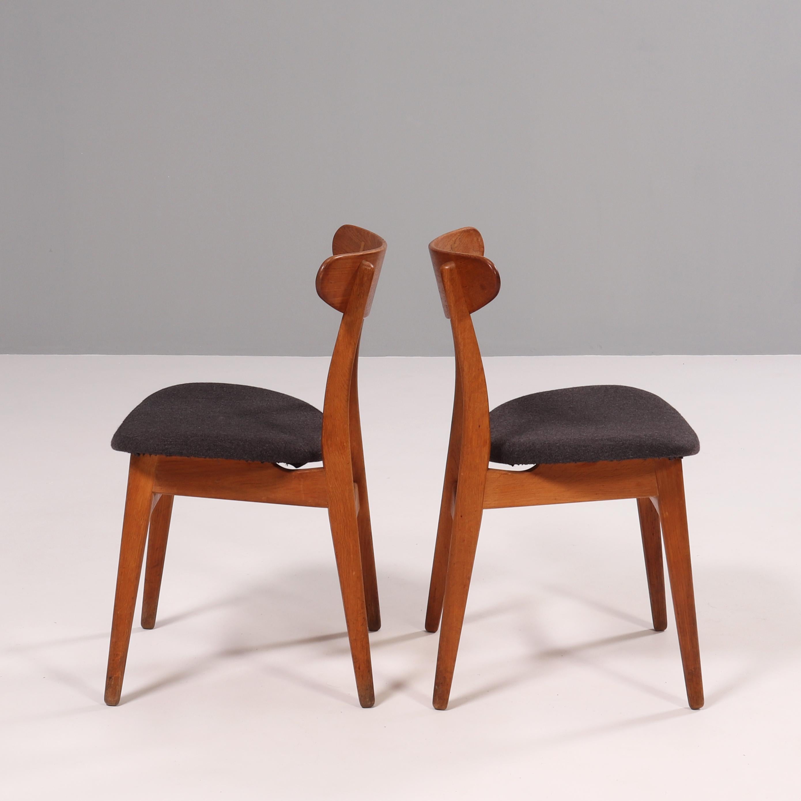 Originally designed by Hans J. Wegner in 1954, the CH30P chair showcases the designers signature style.

Constructed from solid wood, the dining chair features a curved oval backrest with cruciform cover caps, while the seat is upholstered in dark