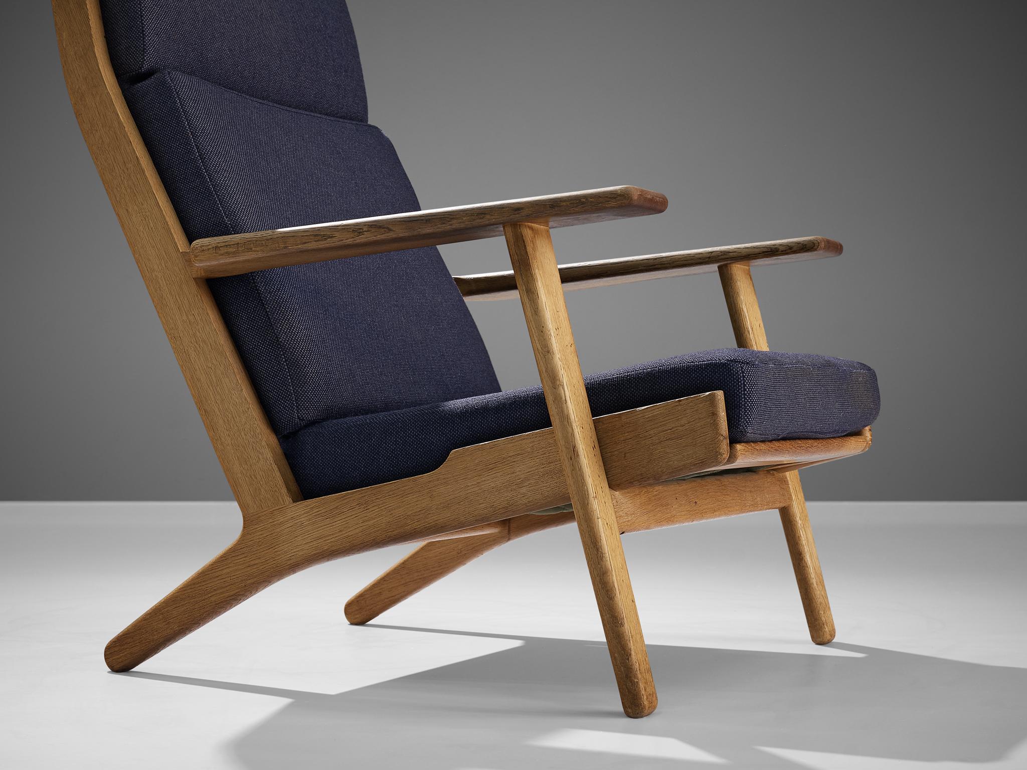 Scandinavian Modern Hans J. Wegner for GETAMA Lounge Chair in Oak and Dark Blue Upholstery  For Sale