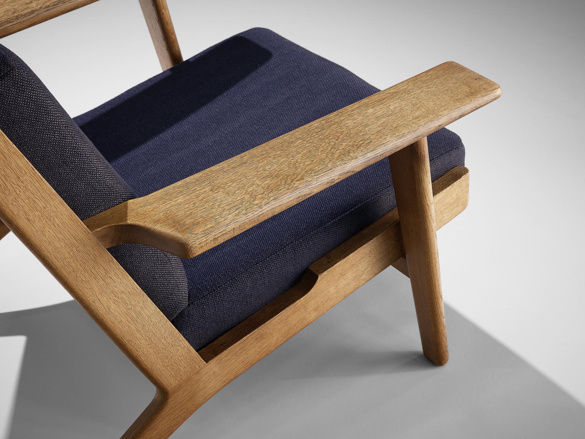 Danish Hans J. Wegner for GETAMA Lounge Chair in Oak and Dark Blue Upholstery  For Sale
