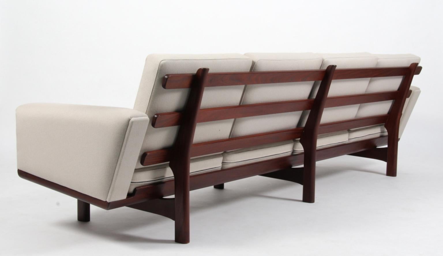 Hans J. Wegner four-seat sofa upholstered with light wool.

Frame in massive teak.

Model 236/4, produced by Getama.
