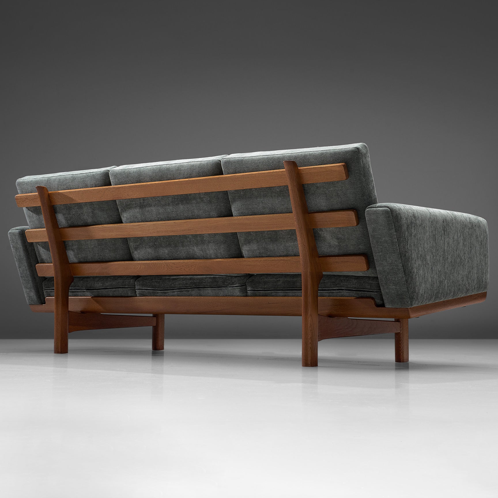 Hans J. Wegner, three-seat sofa model GE-236/3, fabric and oak, Denmark, 1950s

Beautiful sofa by Danish designer Hans J. Wegner. This sofa has a solid oak frame with the construction of the frame visible at the back of the sofa. Due to the high